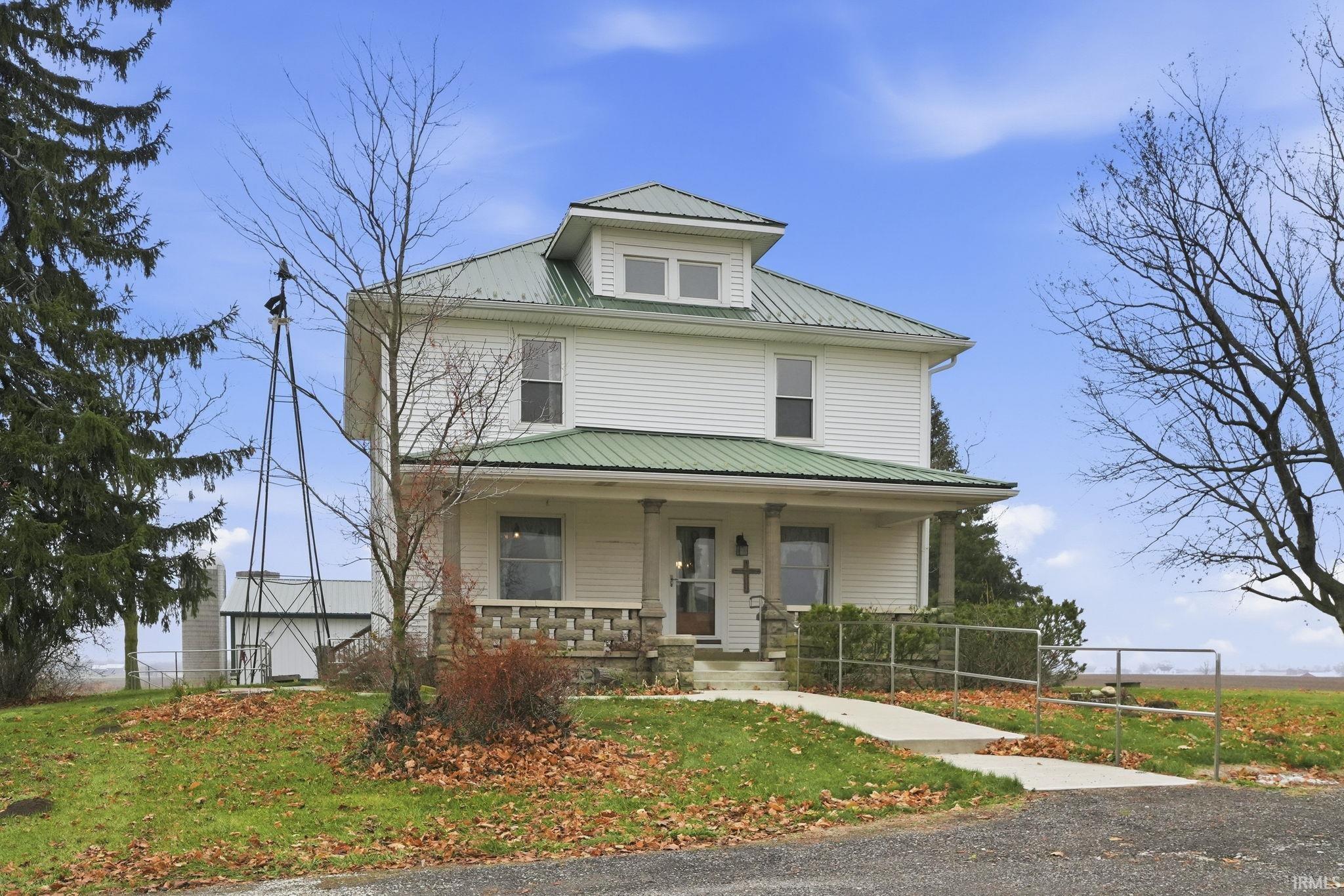 Traditional style home with covered porch and a metal roof
