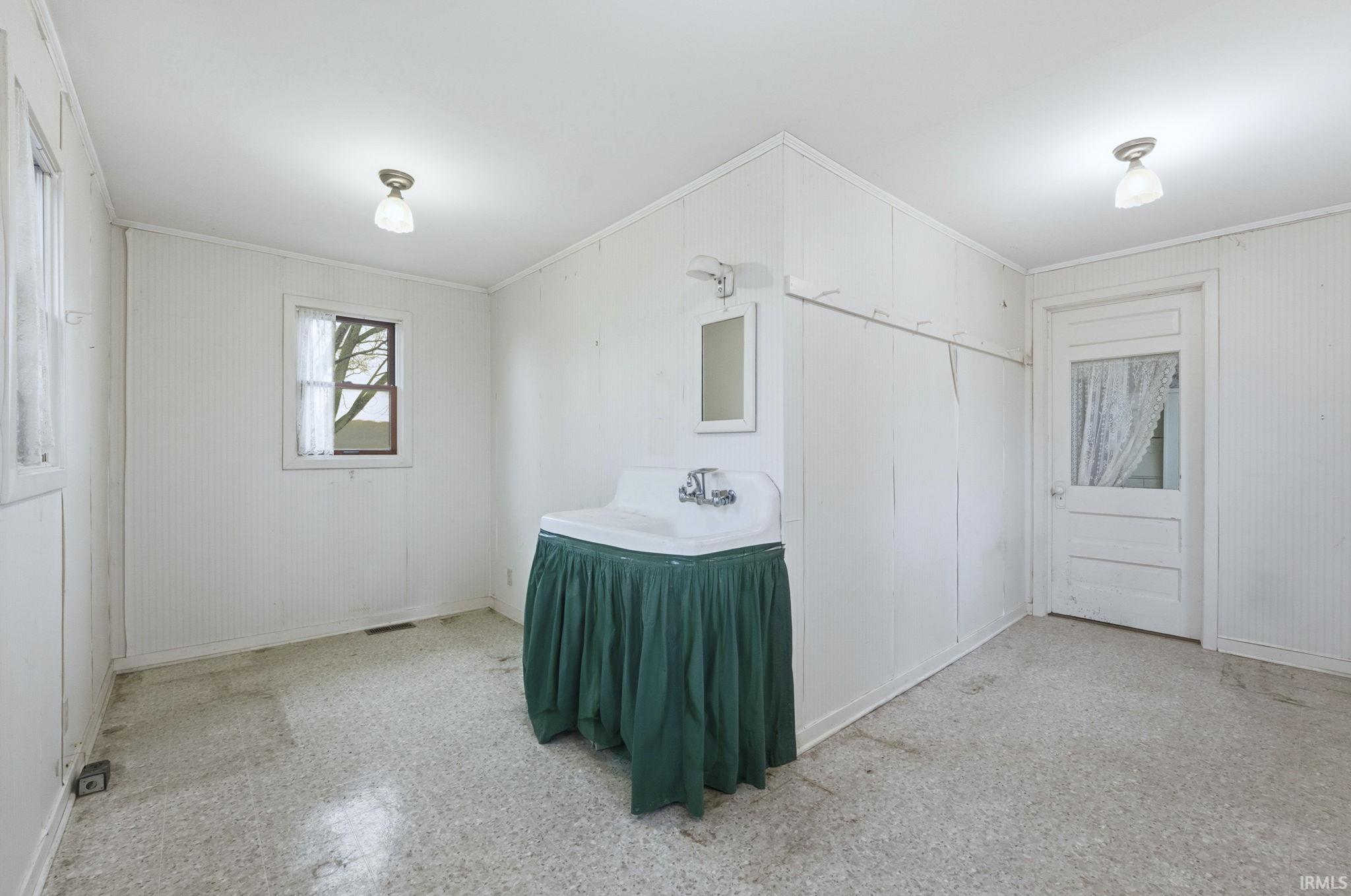 Bathroom featuring vanity and ornamental molding