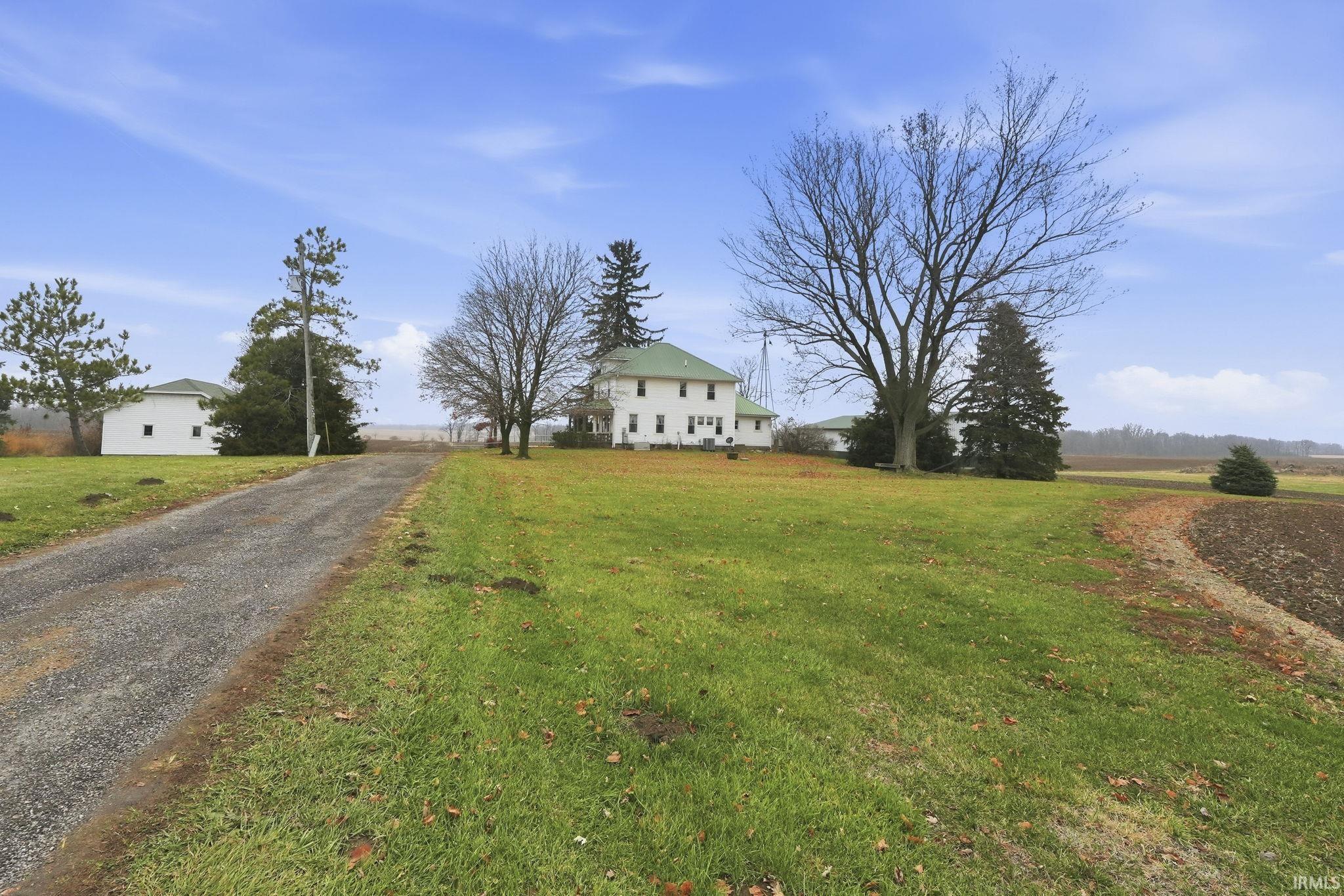 View of front of home featuring a front lawn and a rural view