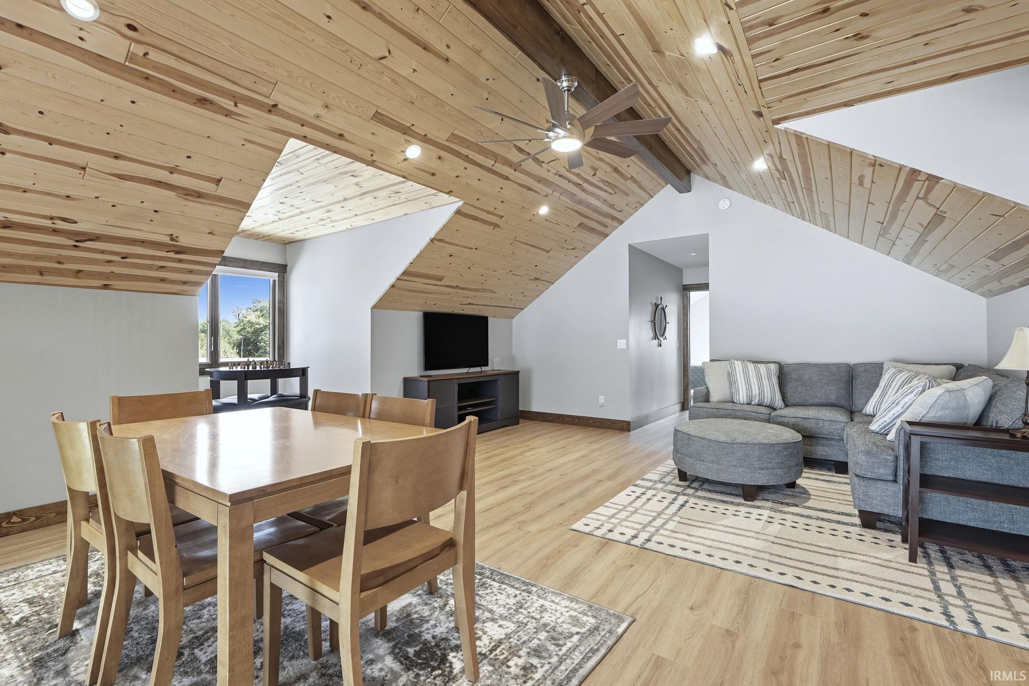 Dining room with a ceiling fan, wooden ceiling, and light wood-style floors