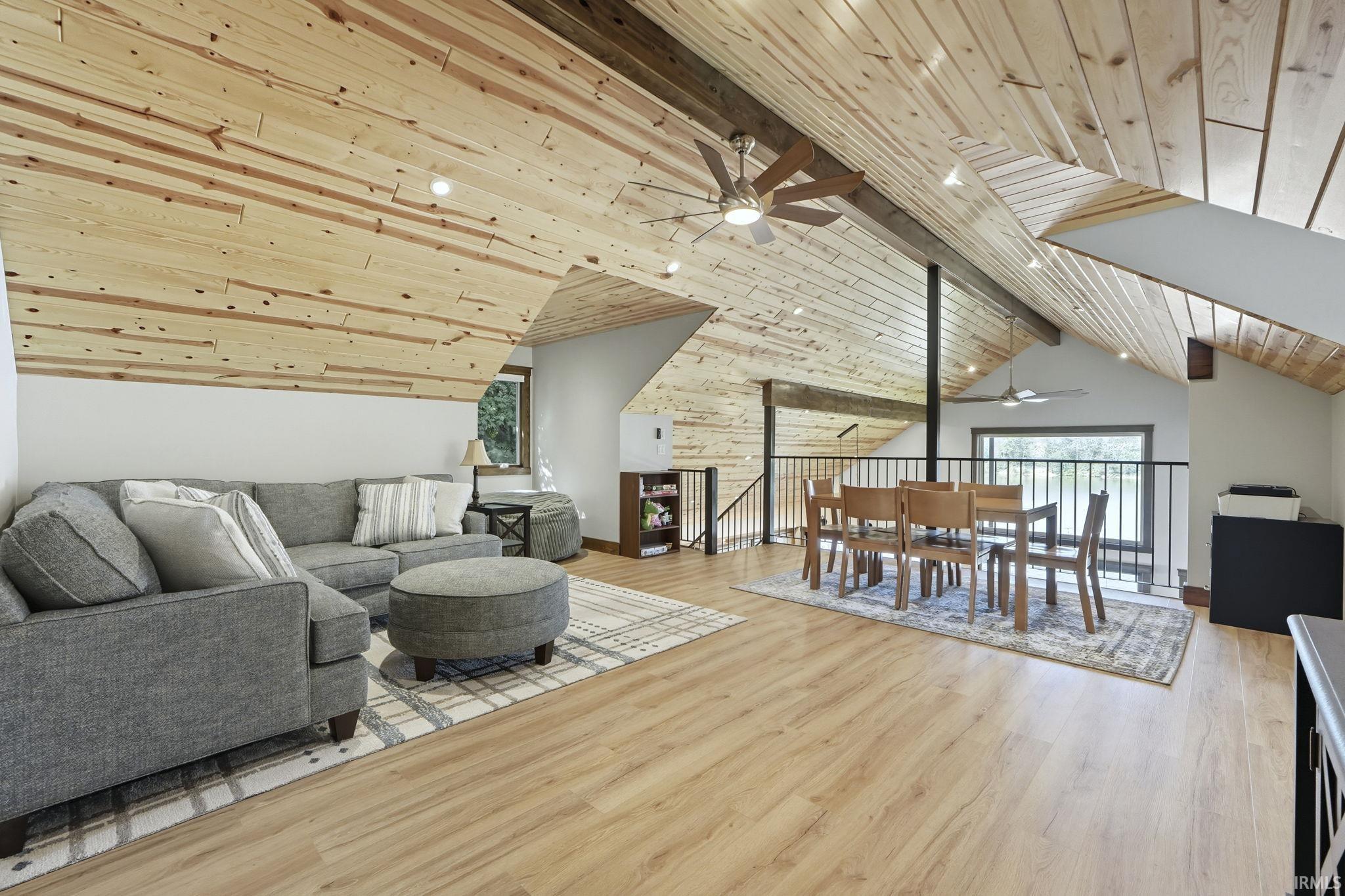 Living room featuring wood ceiling, ceiling fan, and light wood finished floors