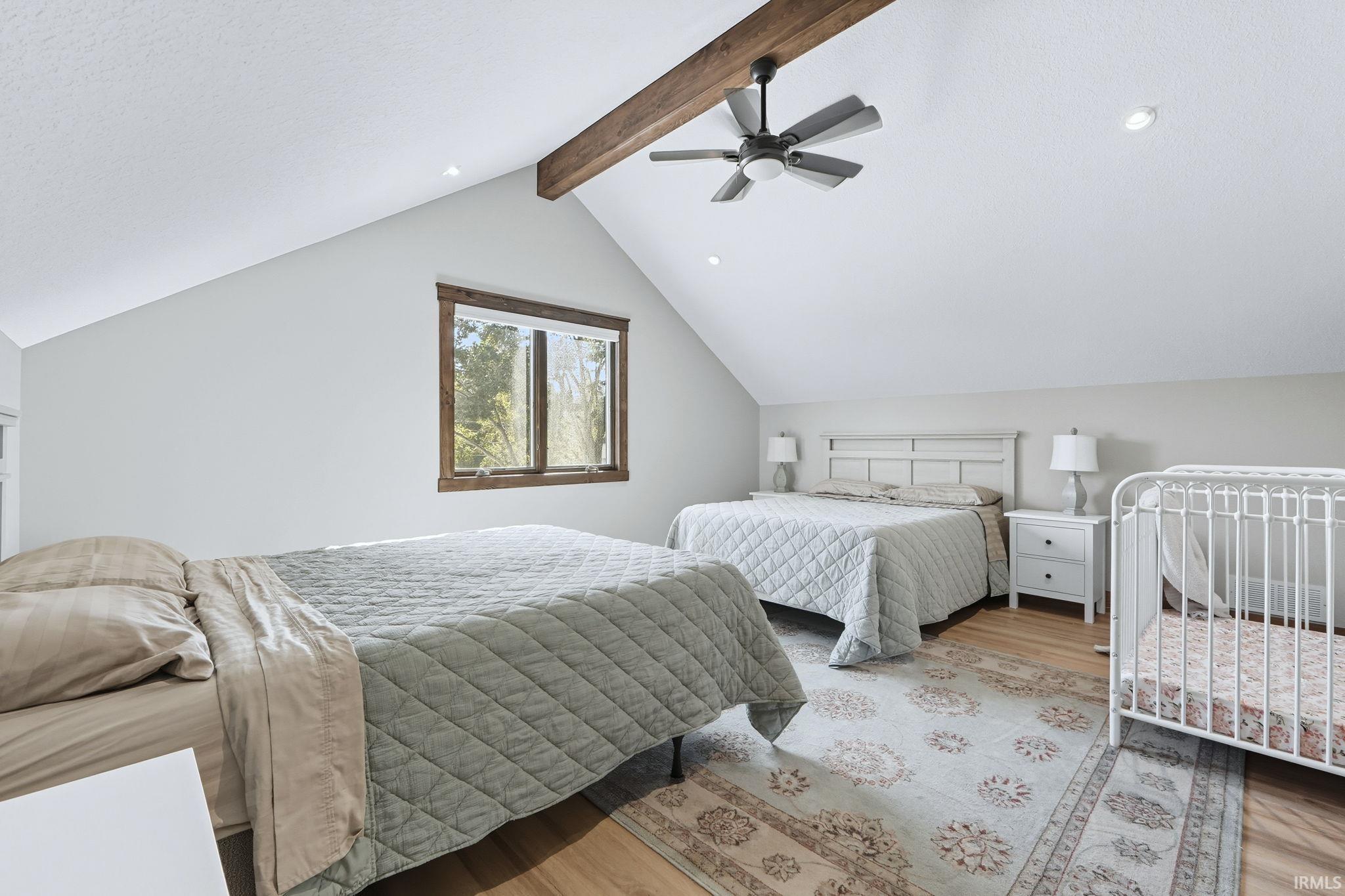 Bedroom featuring light wood-type flooring, ceiling fan, and recessed lighting