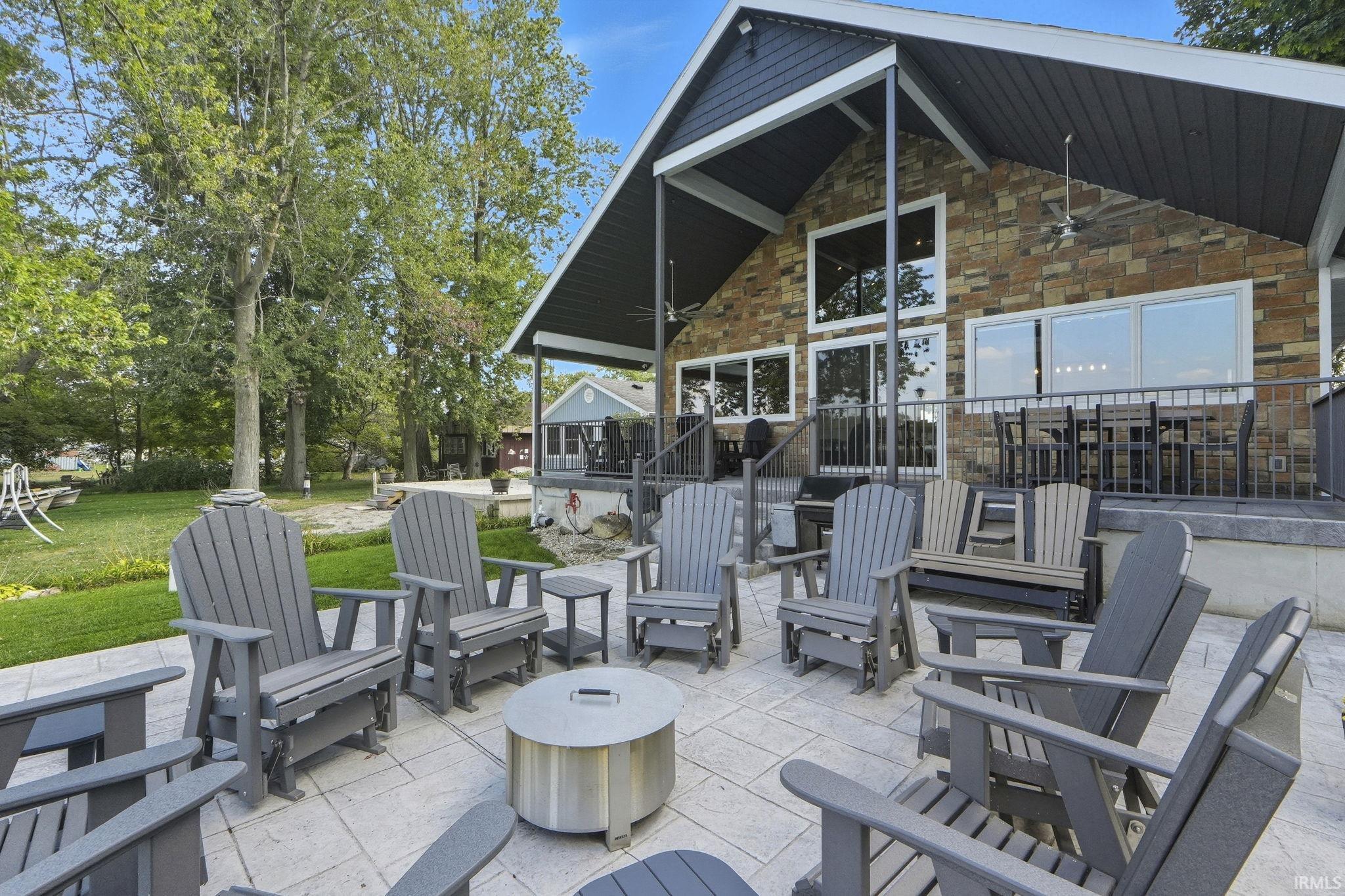 View of patio / terrace with ceiling fan and an outdoor fire pit