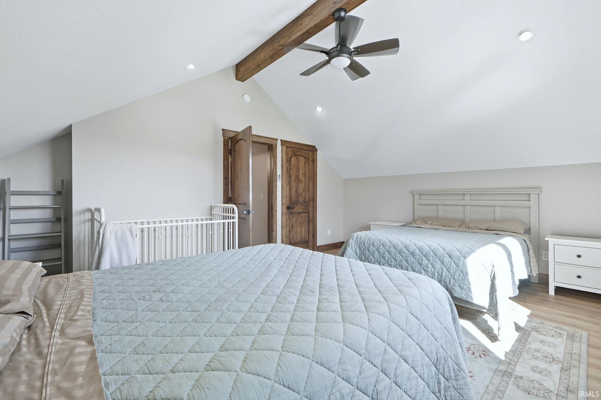Bedroom featuring a ceiling fan, wood finished floors, and recessed lighting