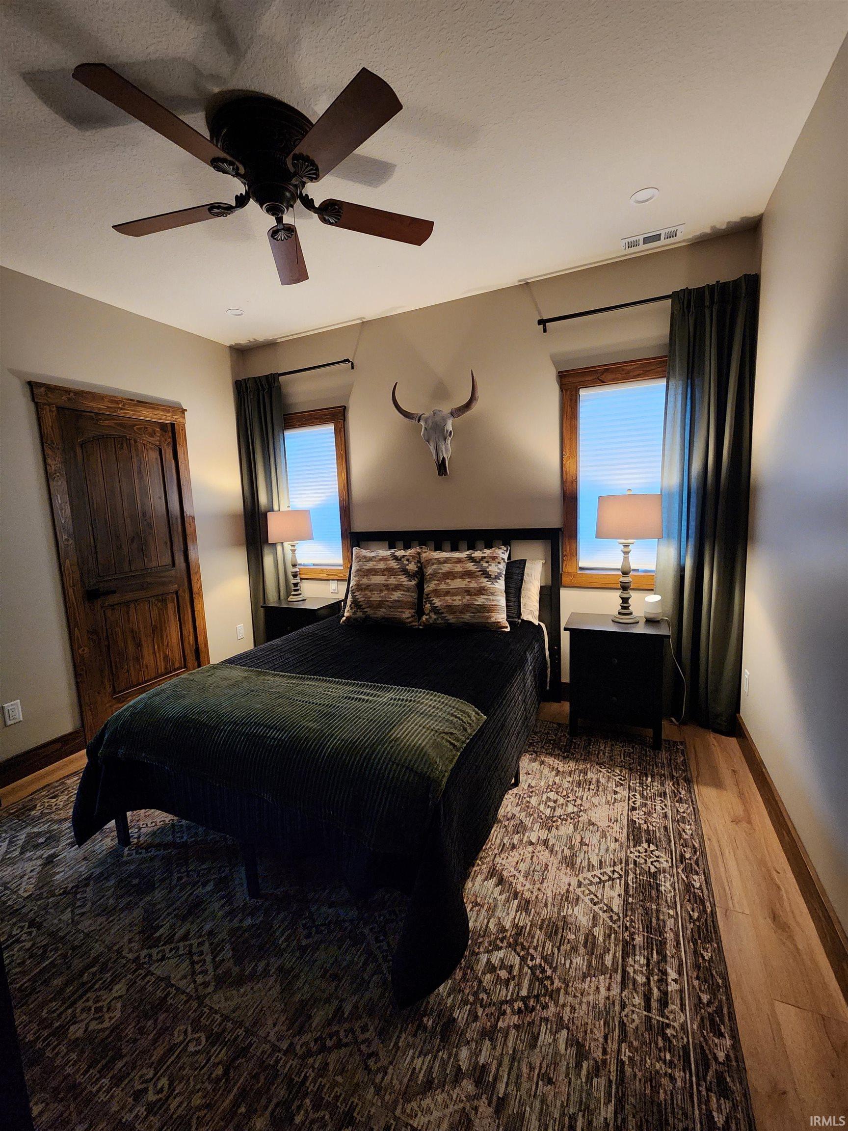 Bedroom featuring wood finished floors and ceiling fan