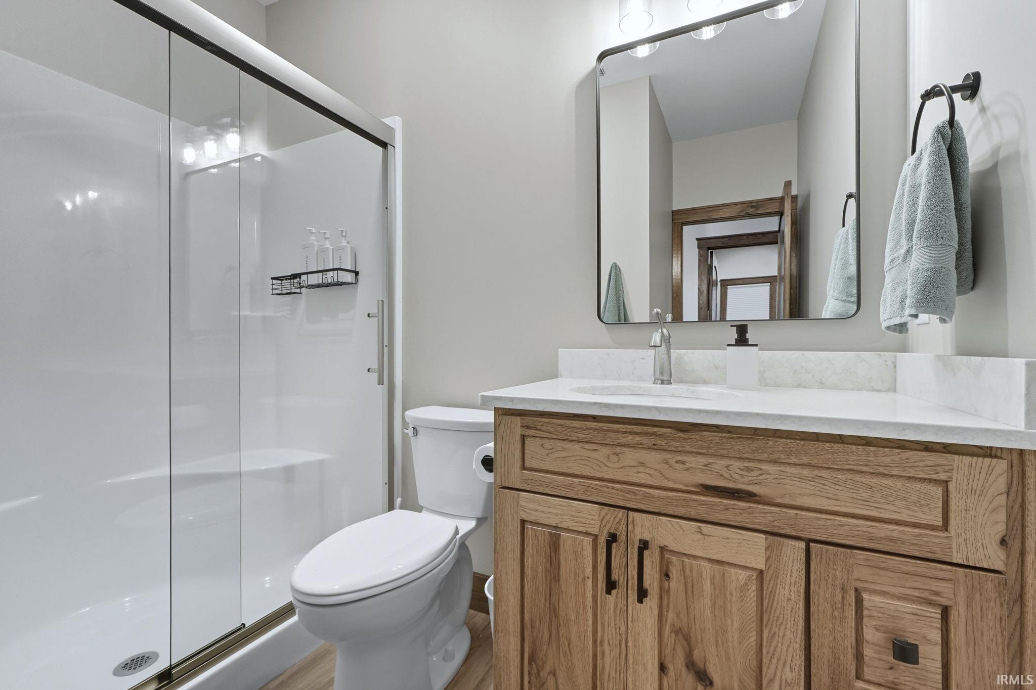 Full bath featuring vanity and a stall shower
