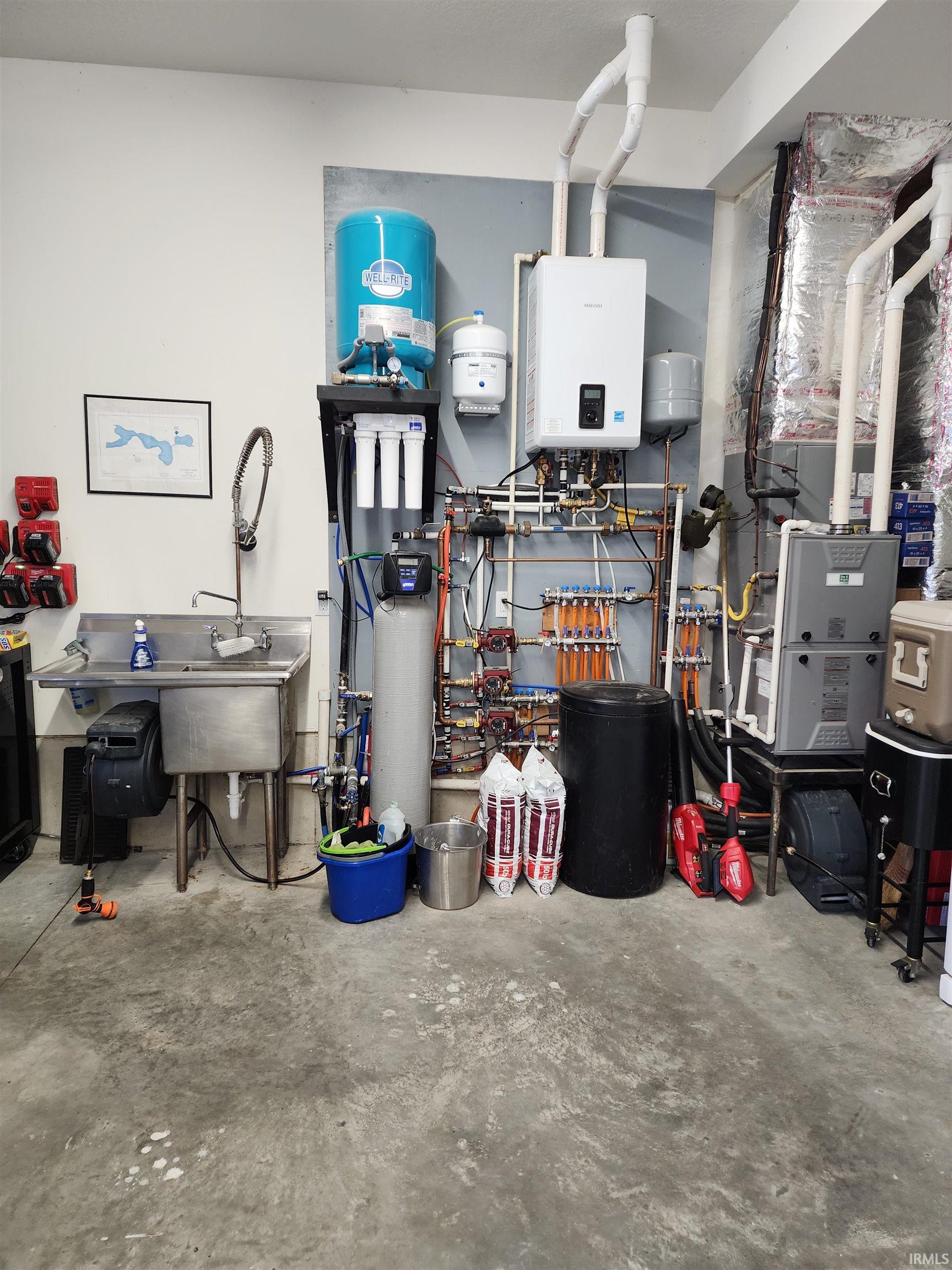 Utility room featuring water heater and heating unit