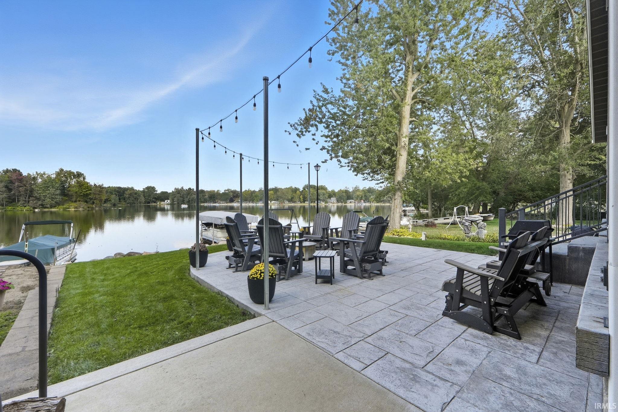 View of patio with a water view and grilling area