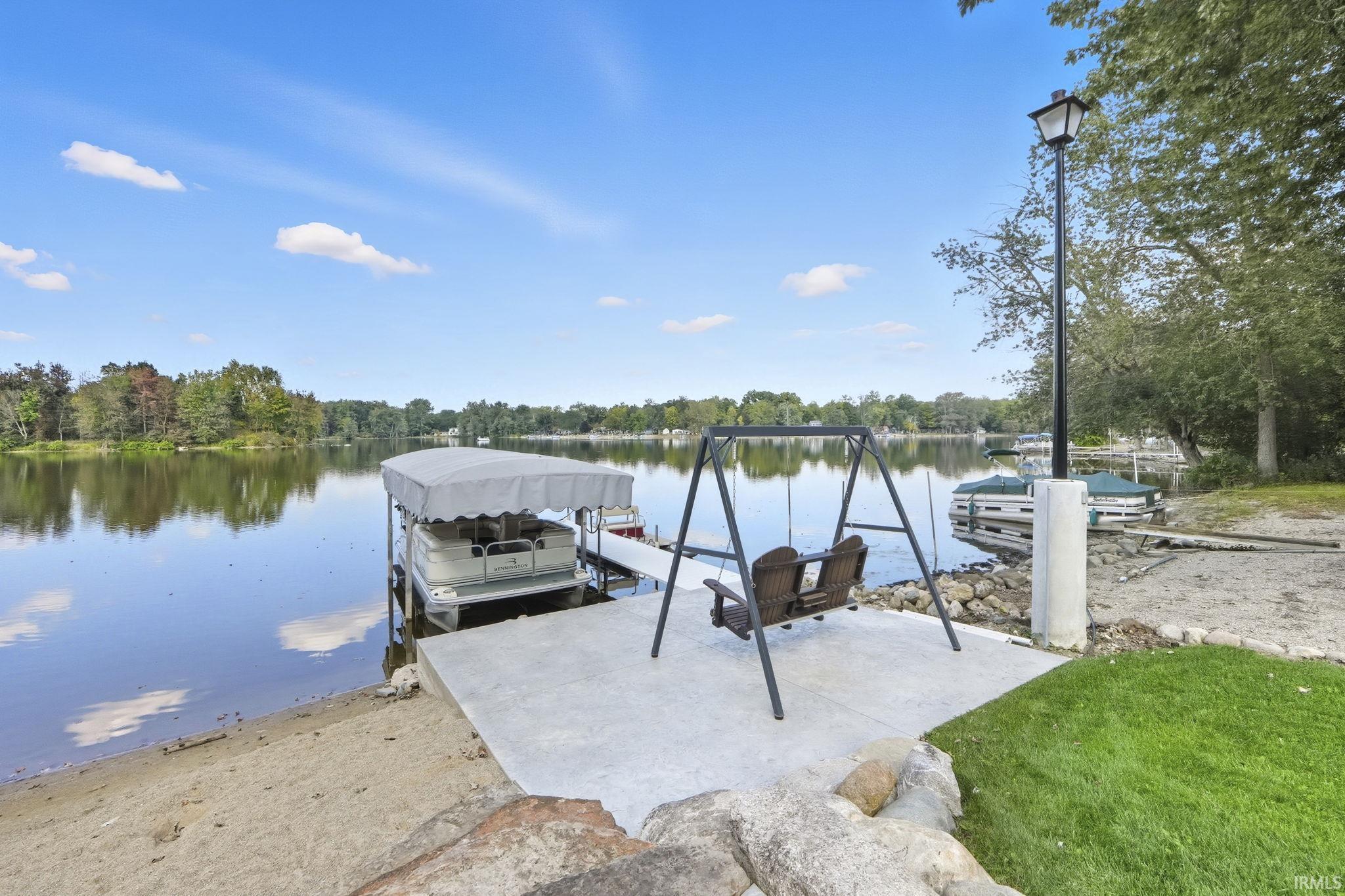 Dock area with a water view and boat lift