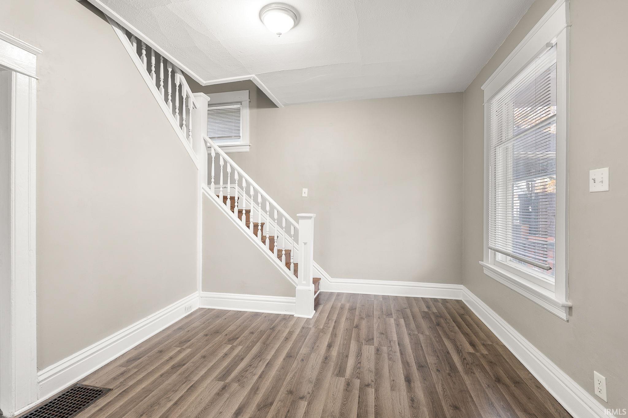 Stairs featuring baseboards and wood finished floors