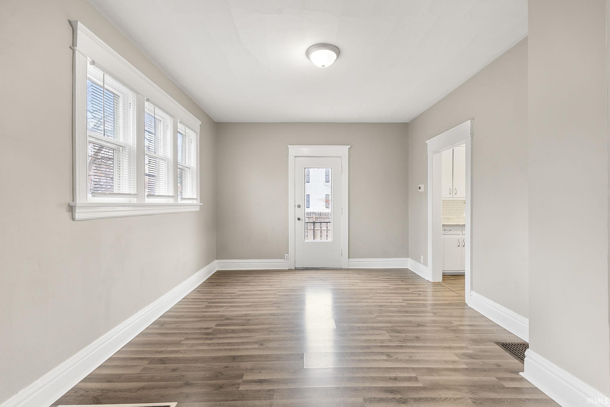 Spare room with light wood-style floors and baseboards
