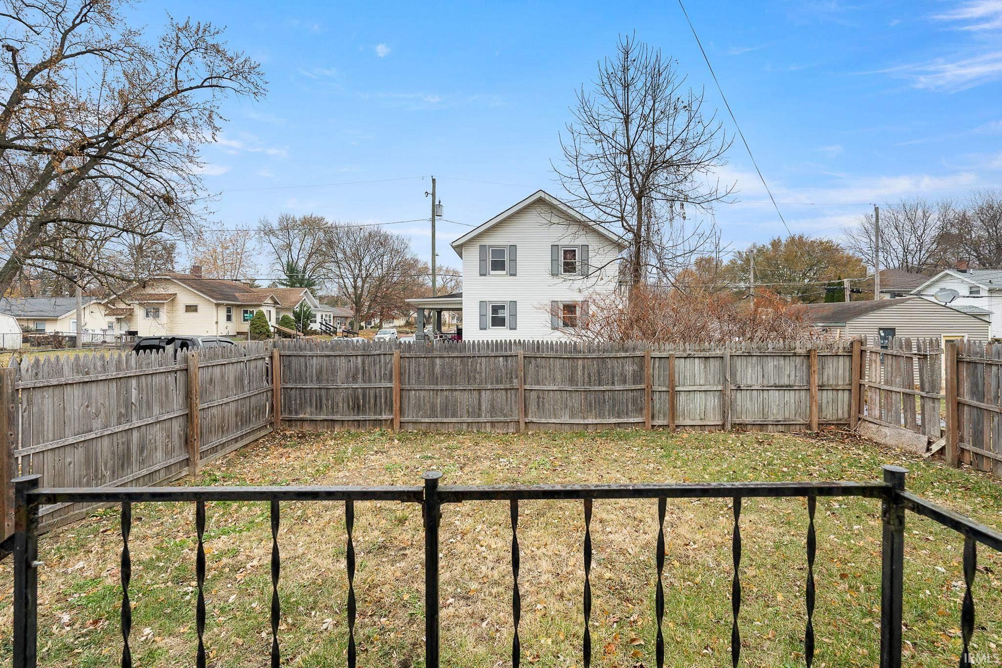 Fenced backyard featuring a residential view