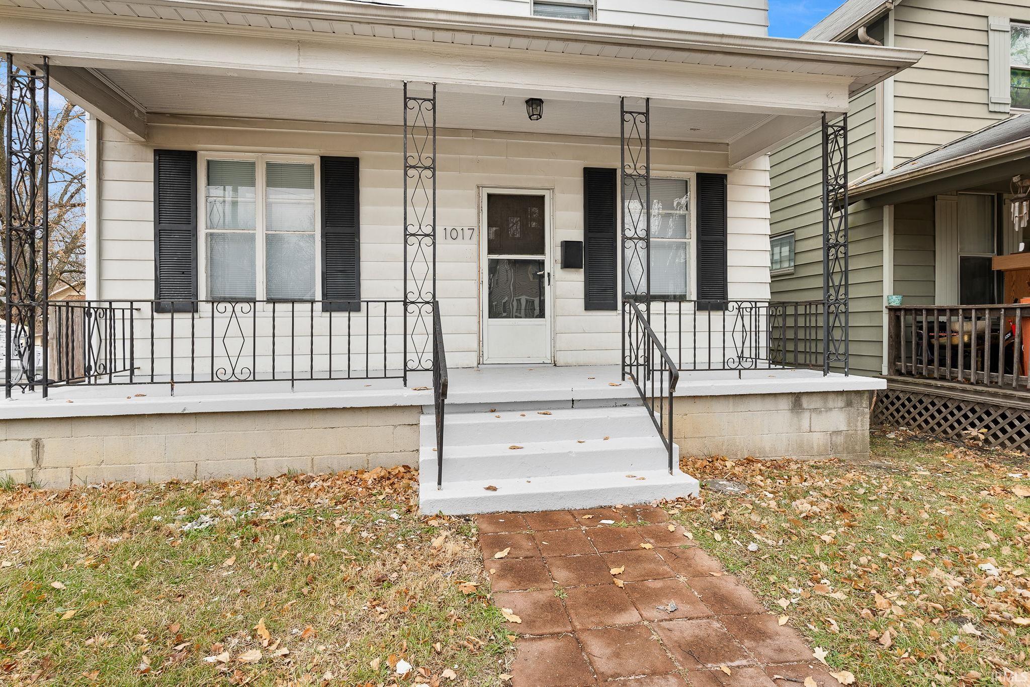 Entrance to property featuring covered porch