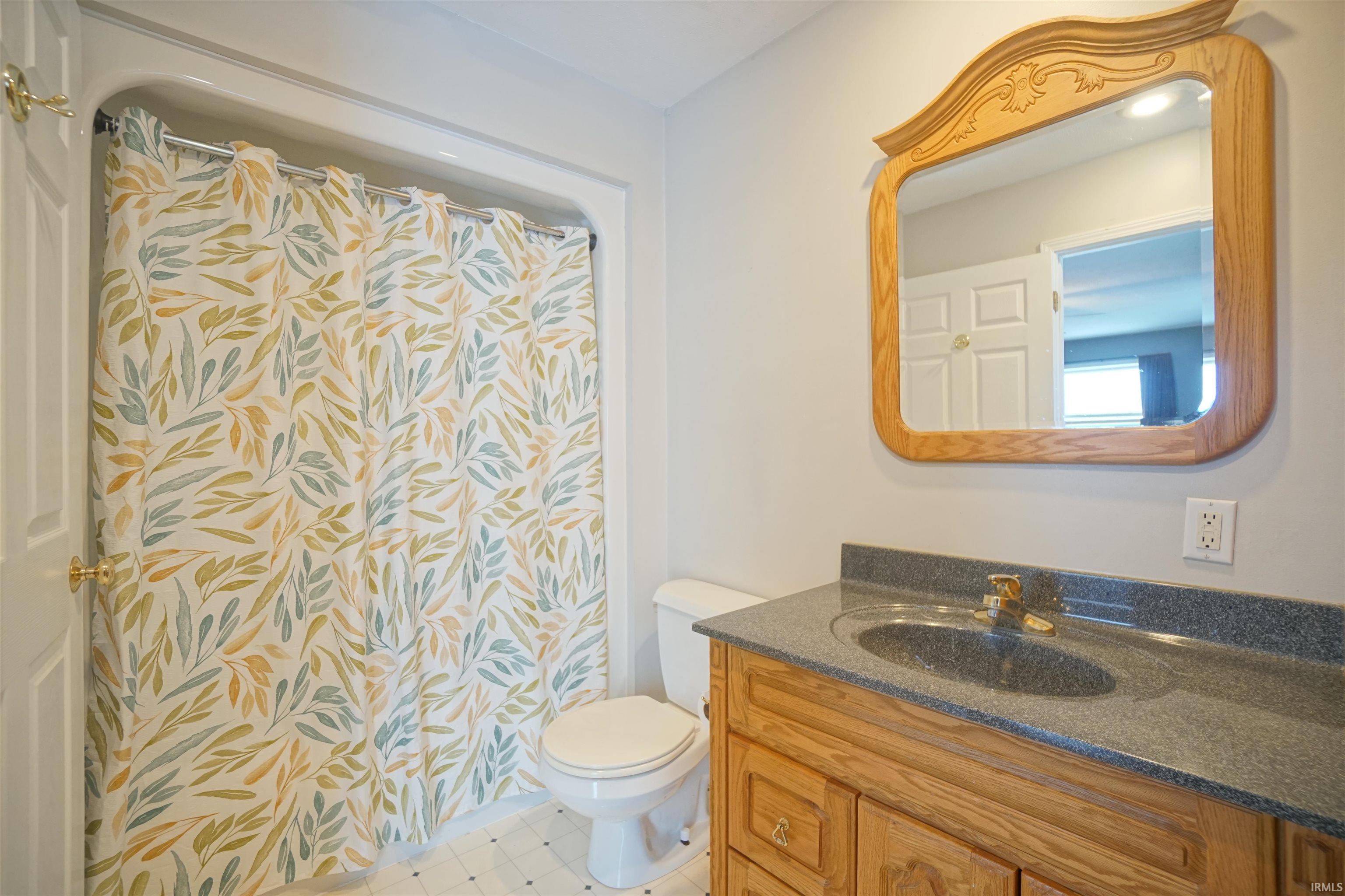 Full bath featuring vanity and a shower with curtain
