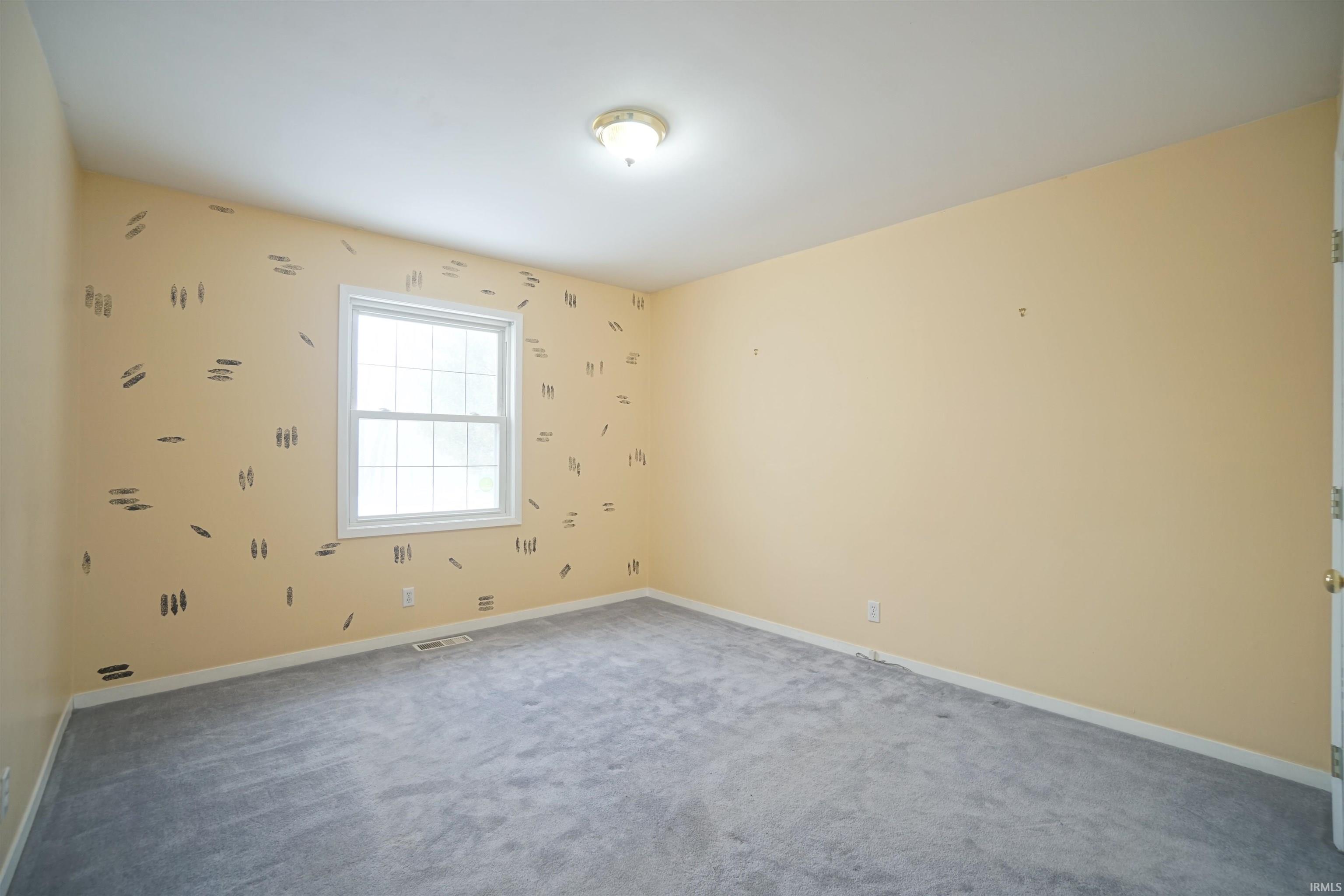Carpeted bedroom with closet