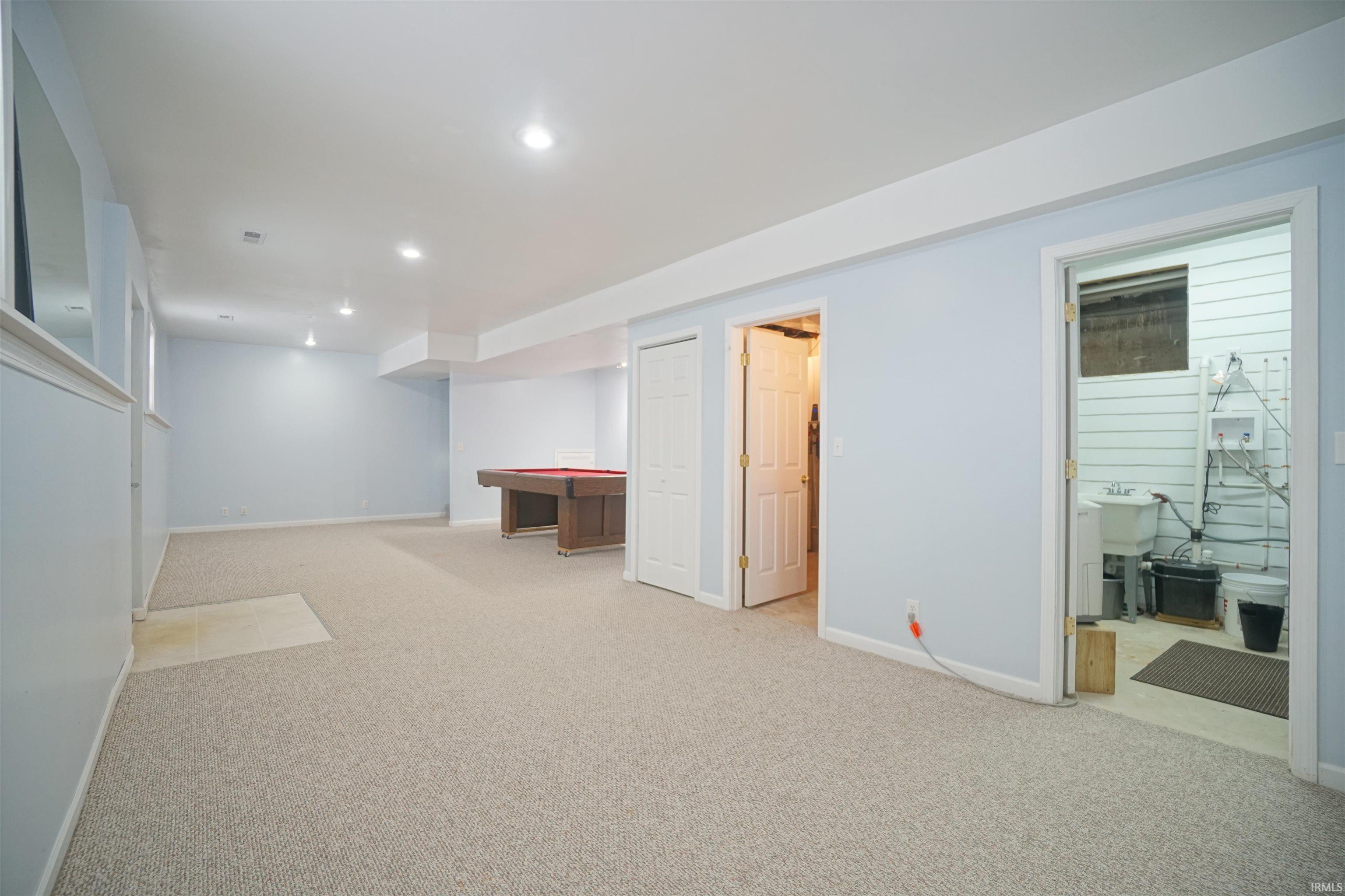 Finished basement featuring light colored carpet and recessed lighting