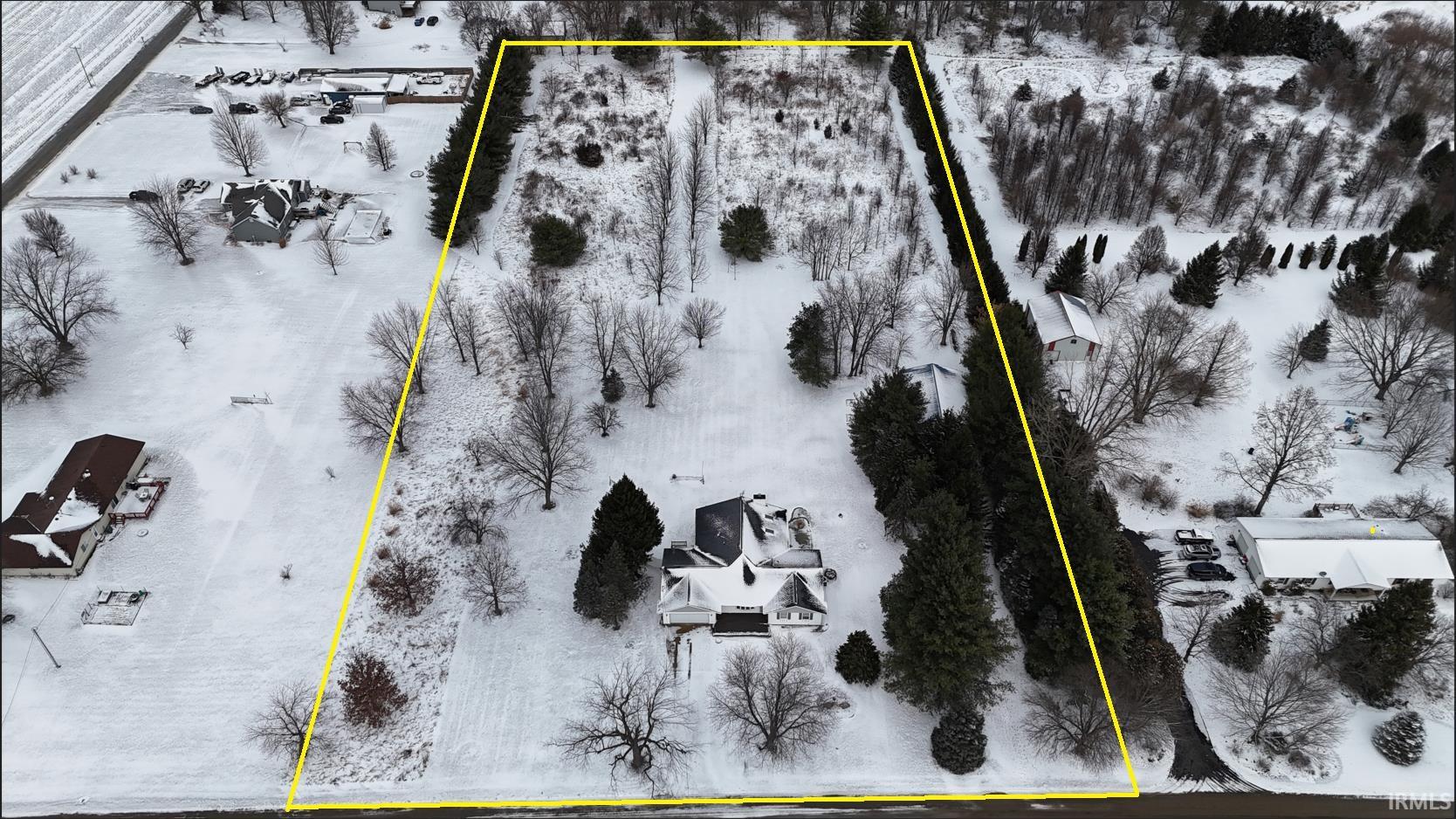 Aerial view of property and surrounding area featuring property parcel outlined