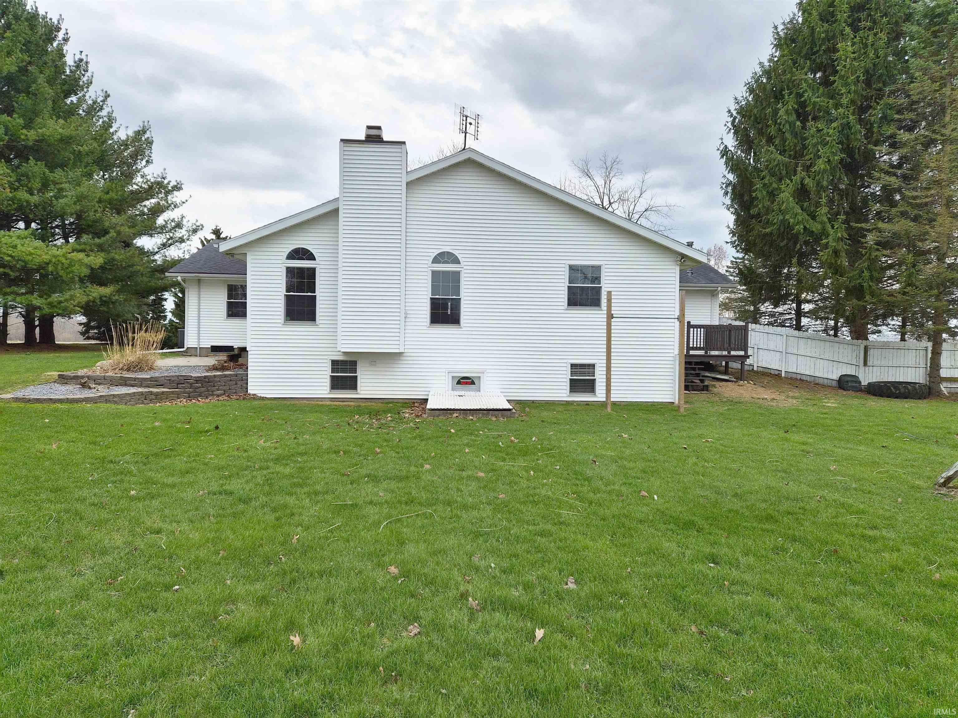 Rear view of house with a chimney and a deck