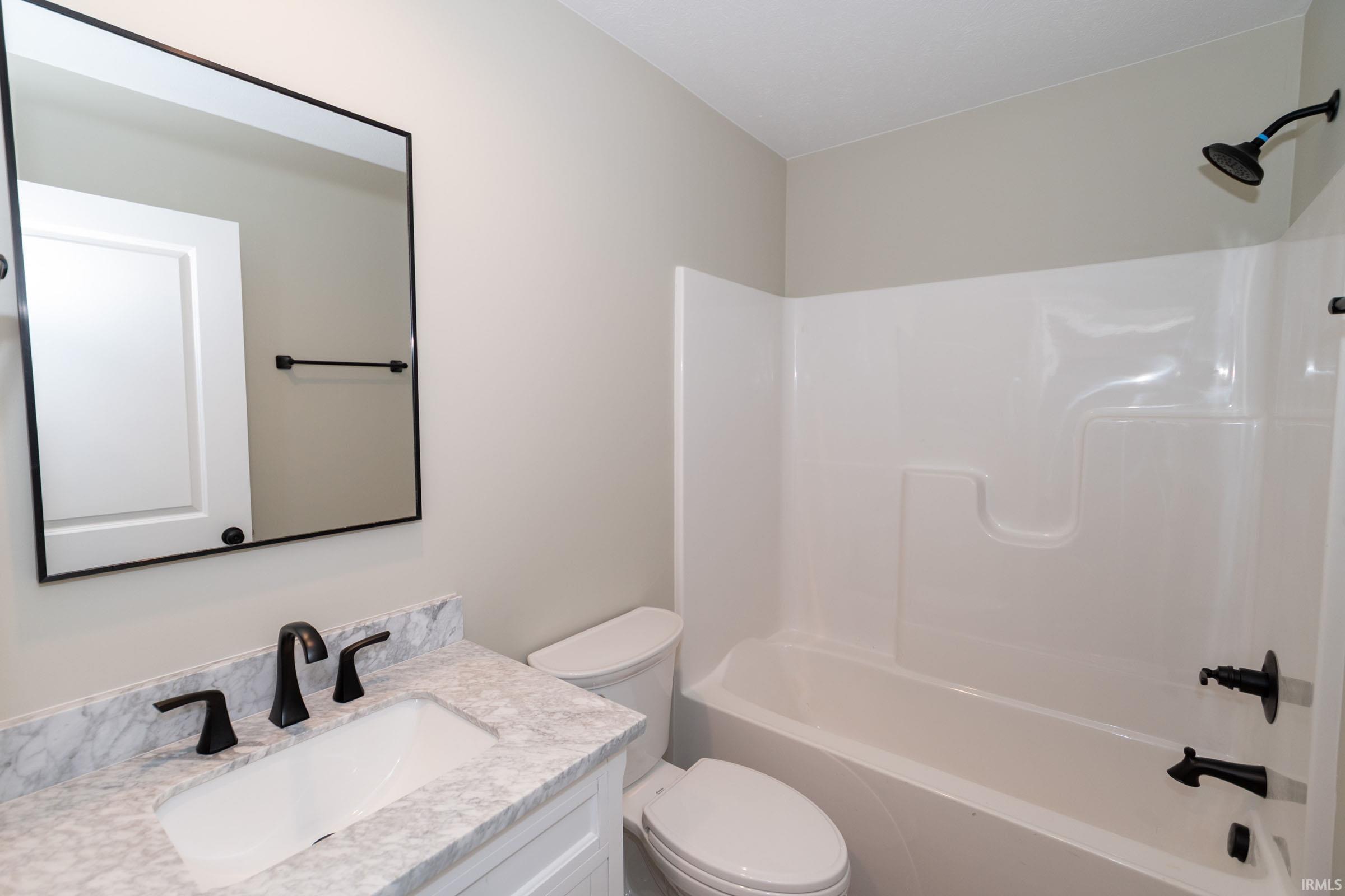 Bathroom featuring bathing tub / shower combination and vanity