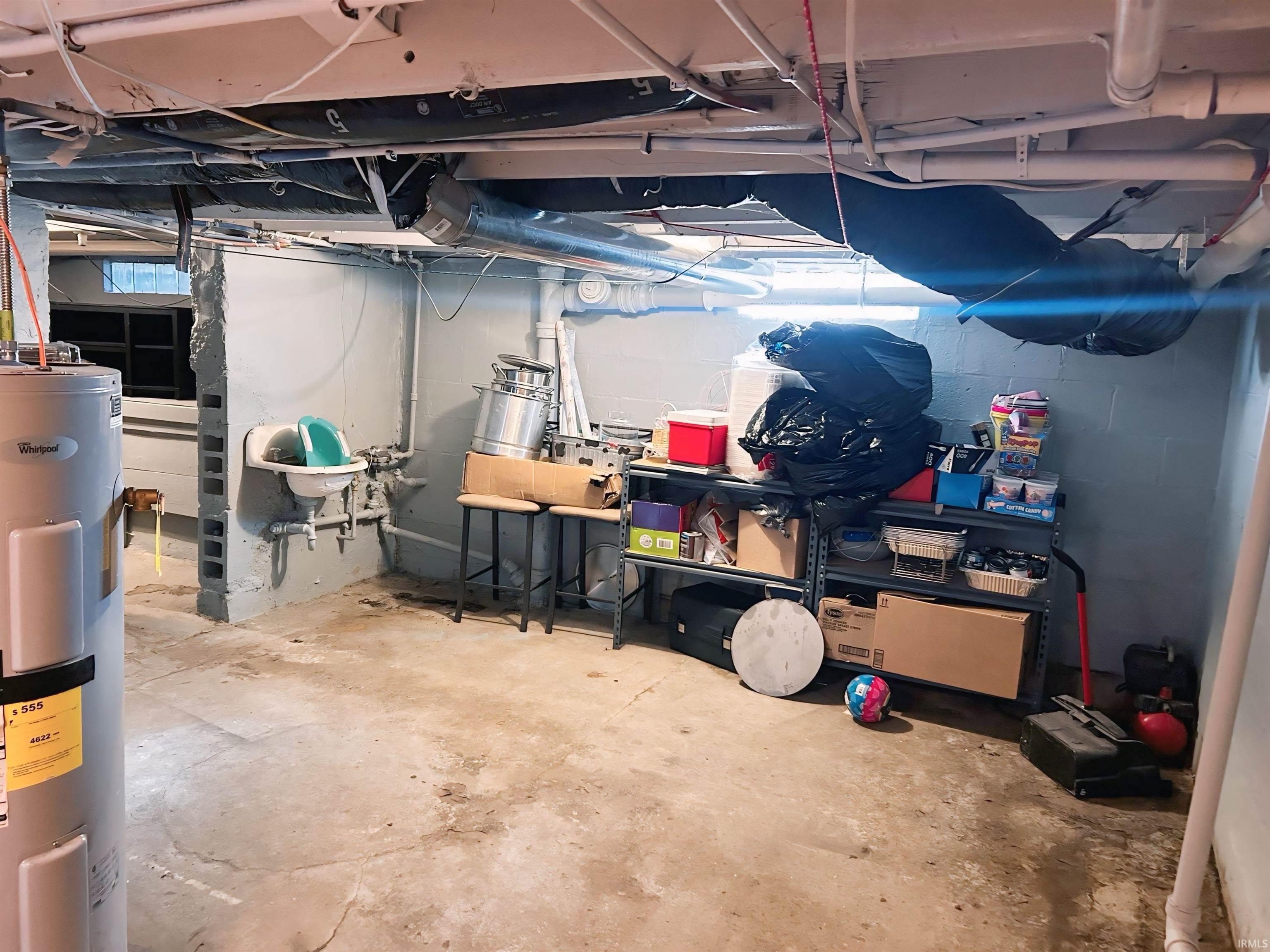 Unfinished basement featuring electric water heater
