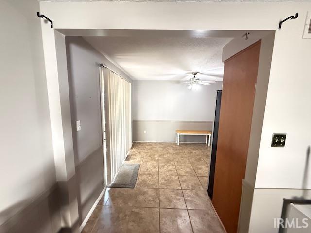 Corridor with light tile patterned floors