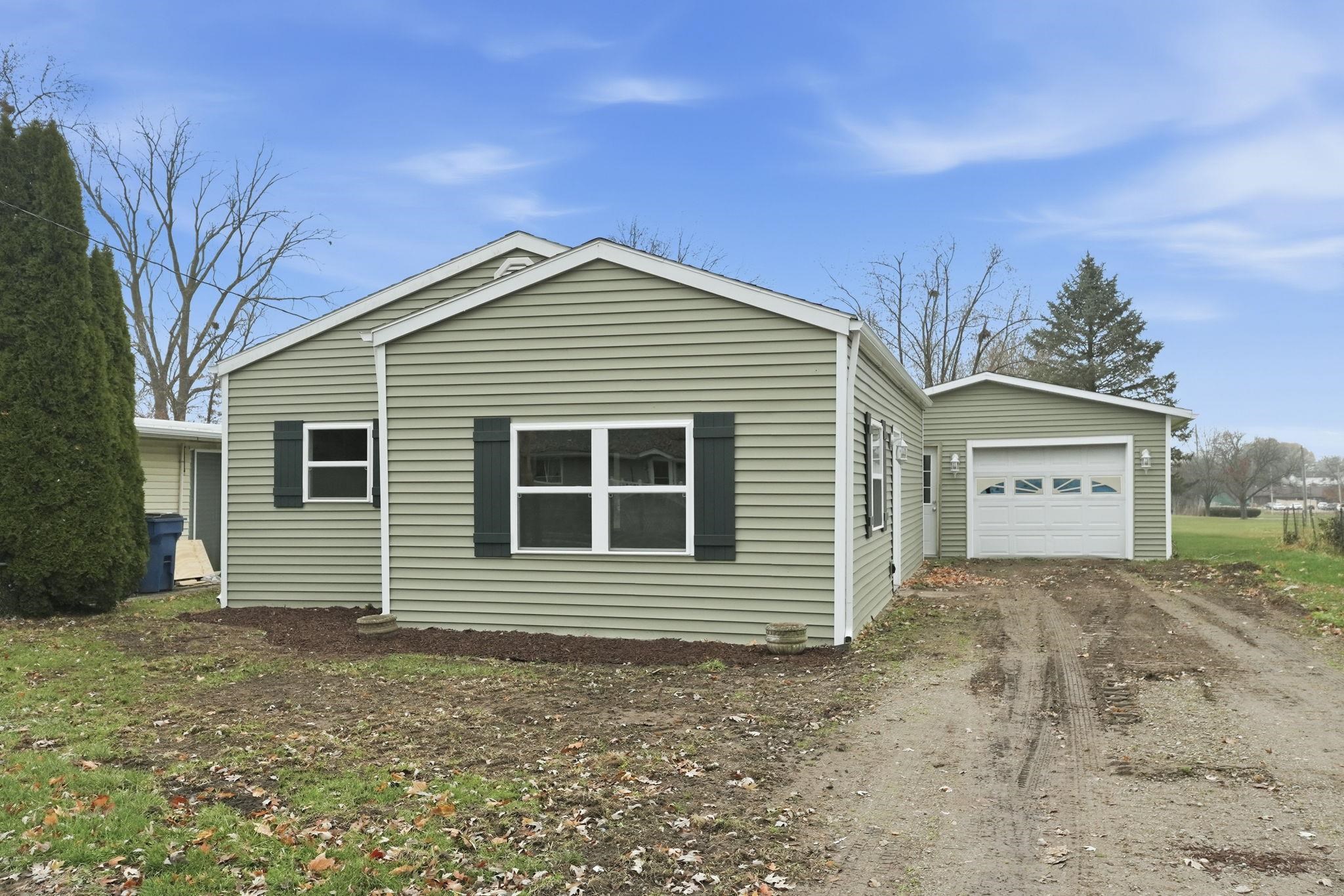 View of property exterior featuring dirt driveway