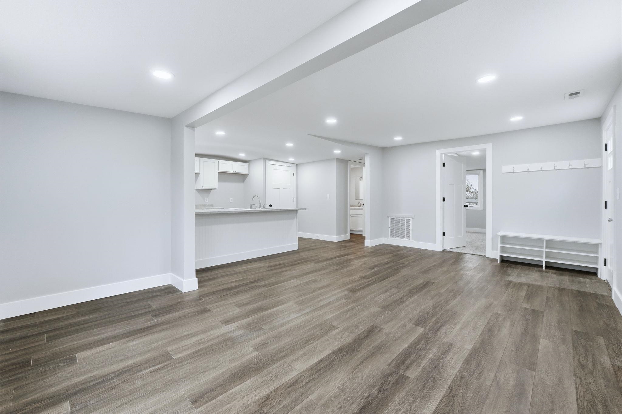 Unfurnished living room with dark wood finished floors and recessed lighting