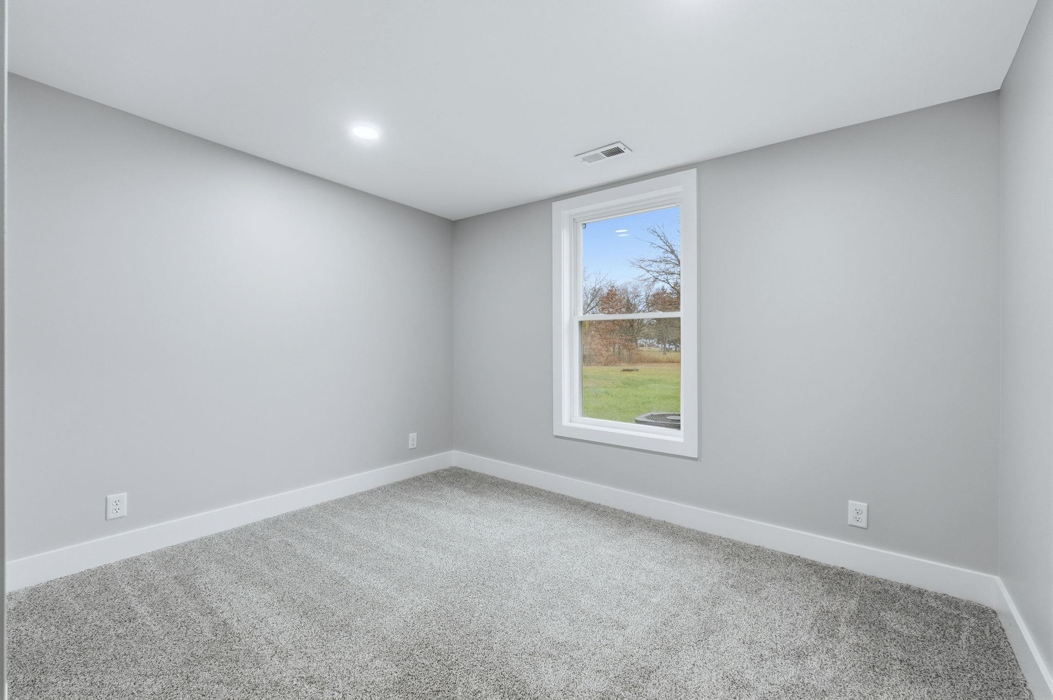 Carpeted empty room with baseboards