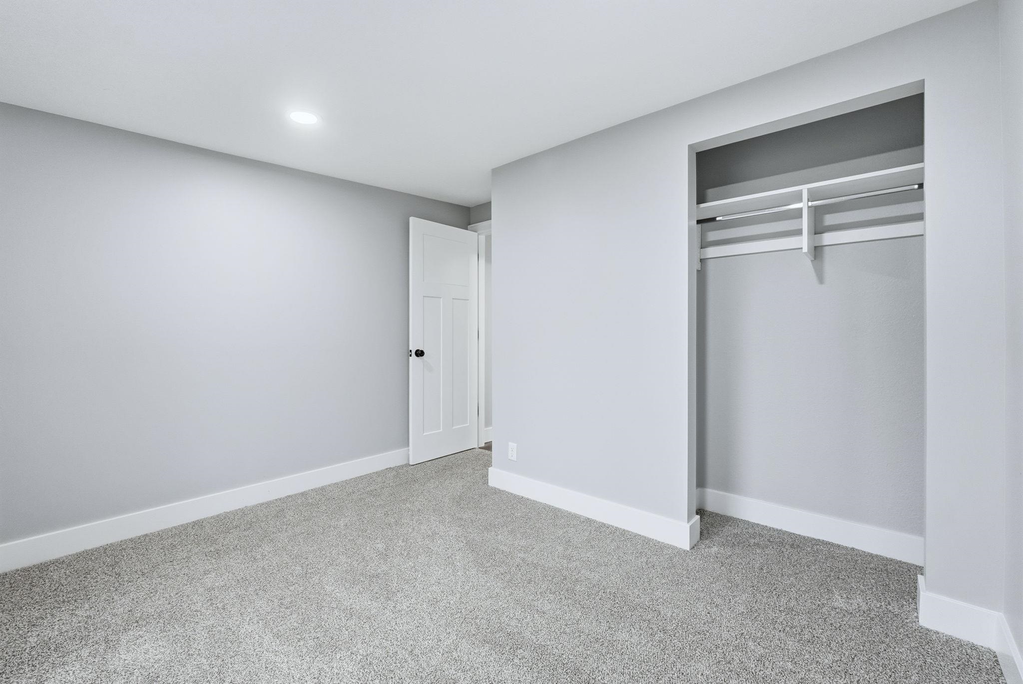 Unfurnished bedroom with carpet and a closet