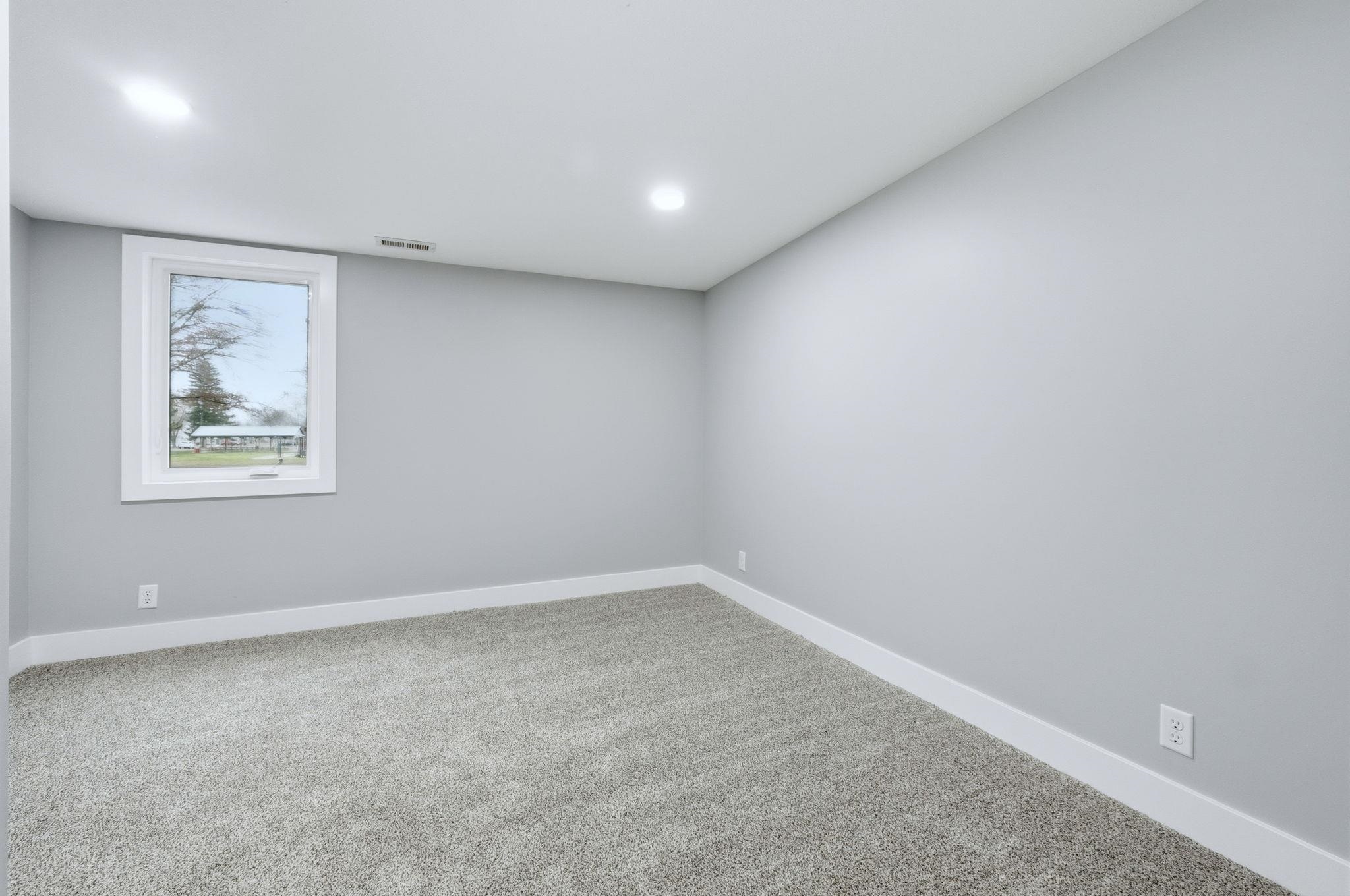 Carpeted spare room with baseboards