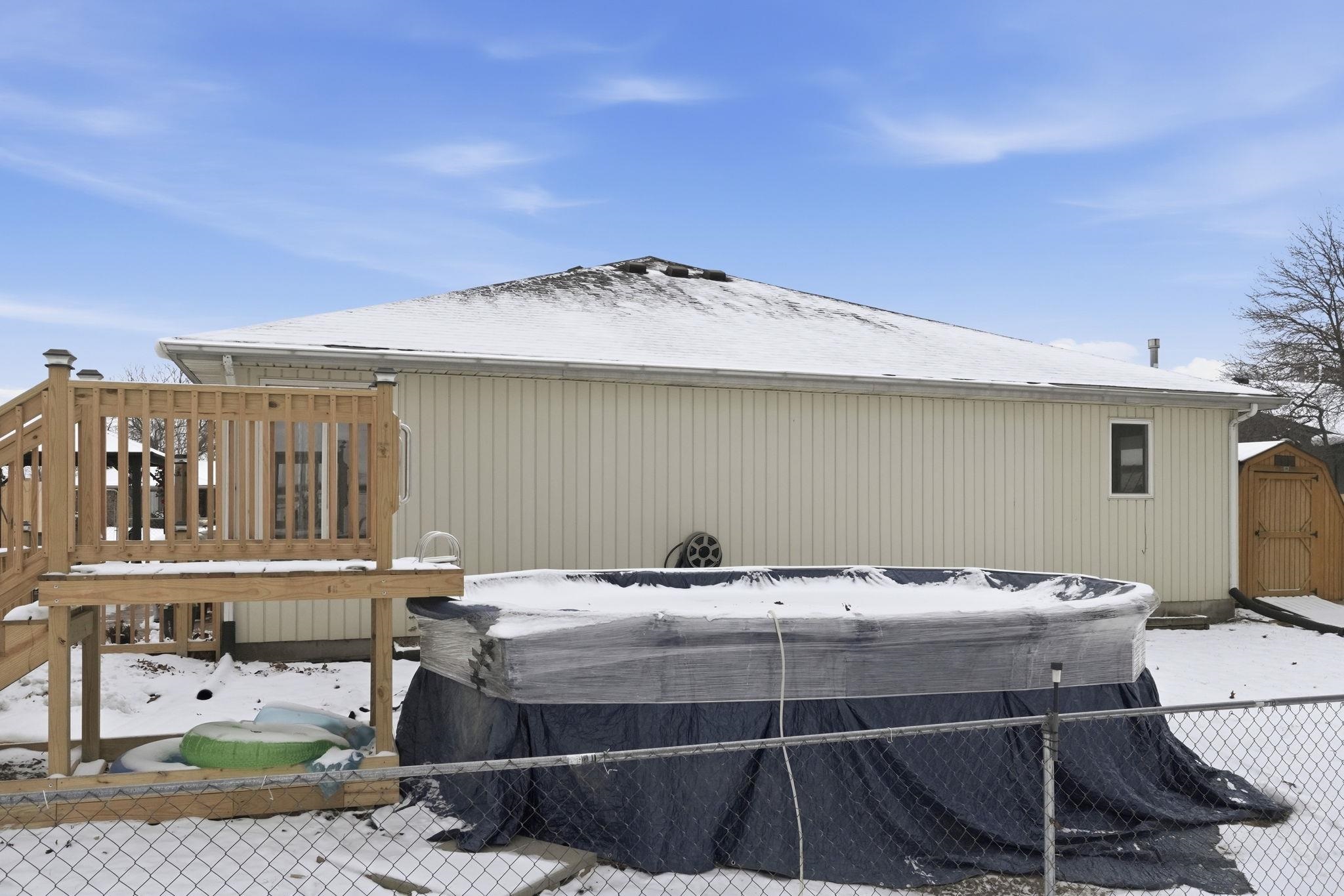 Ranch-style home with concrete driveway, an attached garage, brick siding, and a front lawn