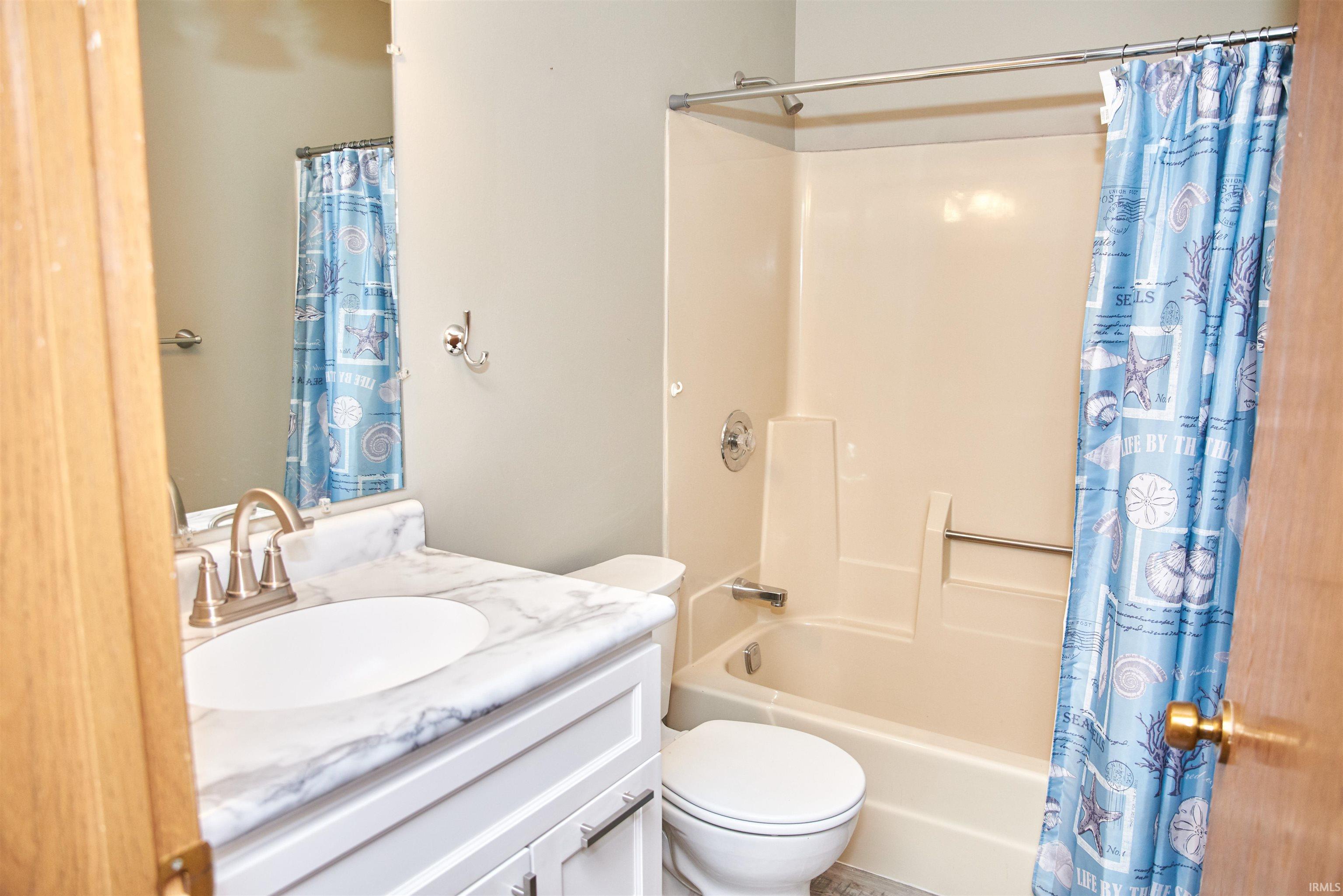 Full bath with vanity and shower / bath combo