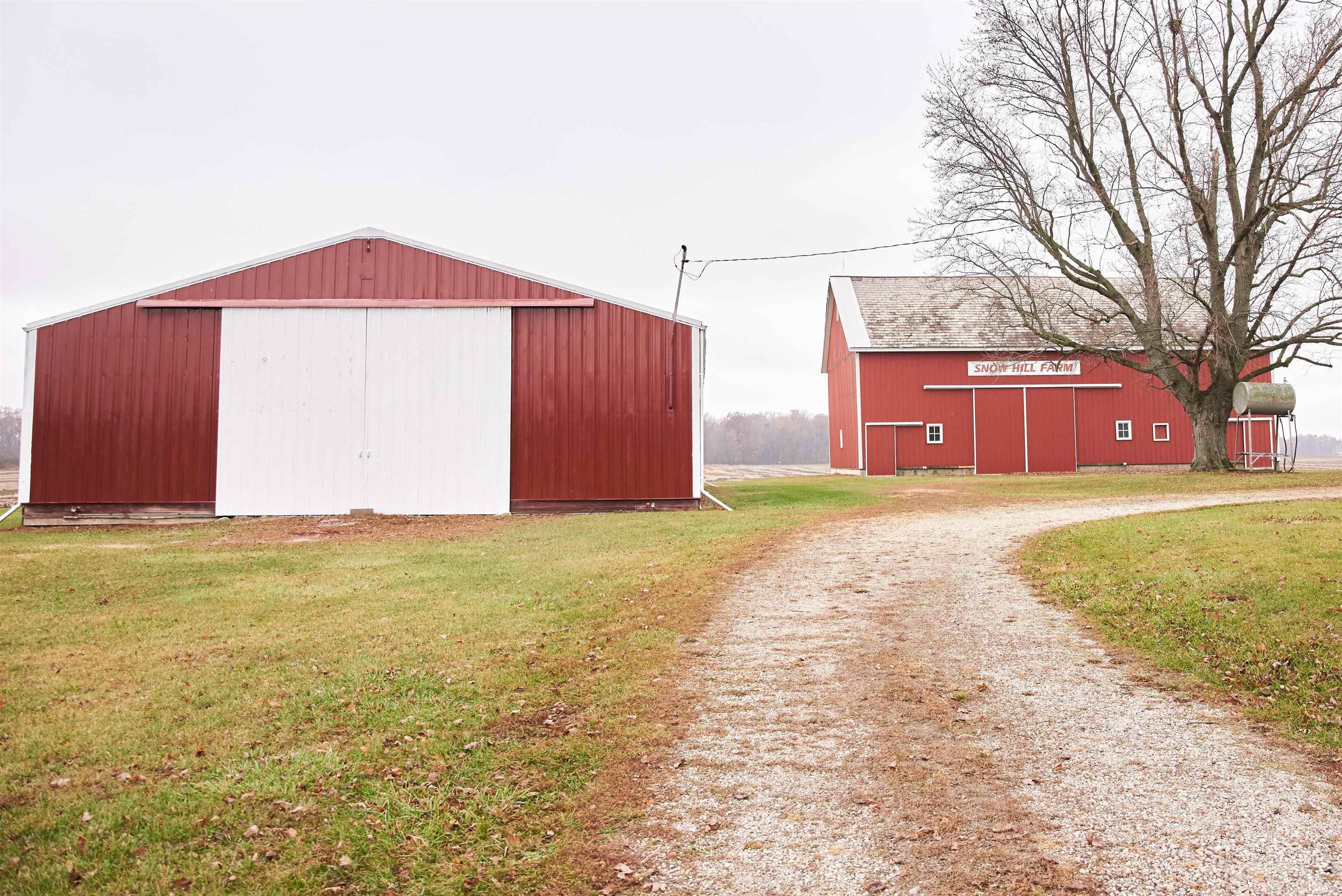View of pole building featuring a yard and driveway