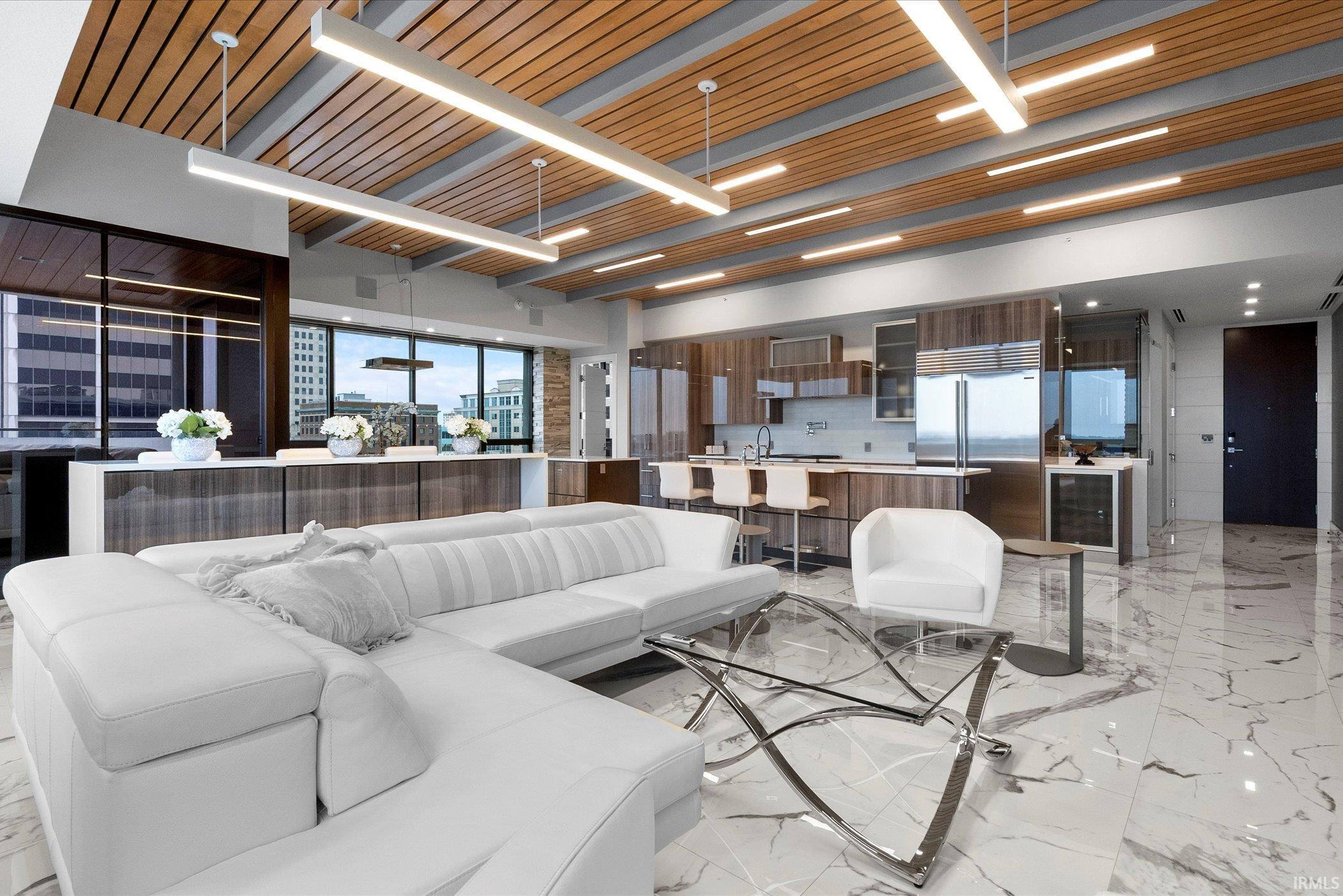 Living area featuring light marble finish flooring, wine cooler, and wooden ceiling