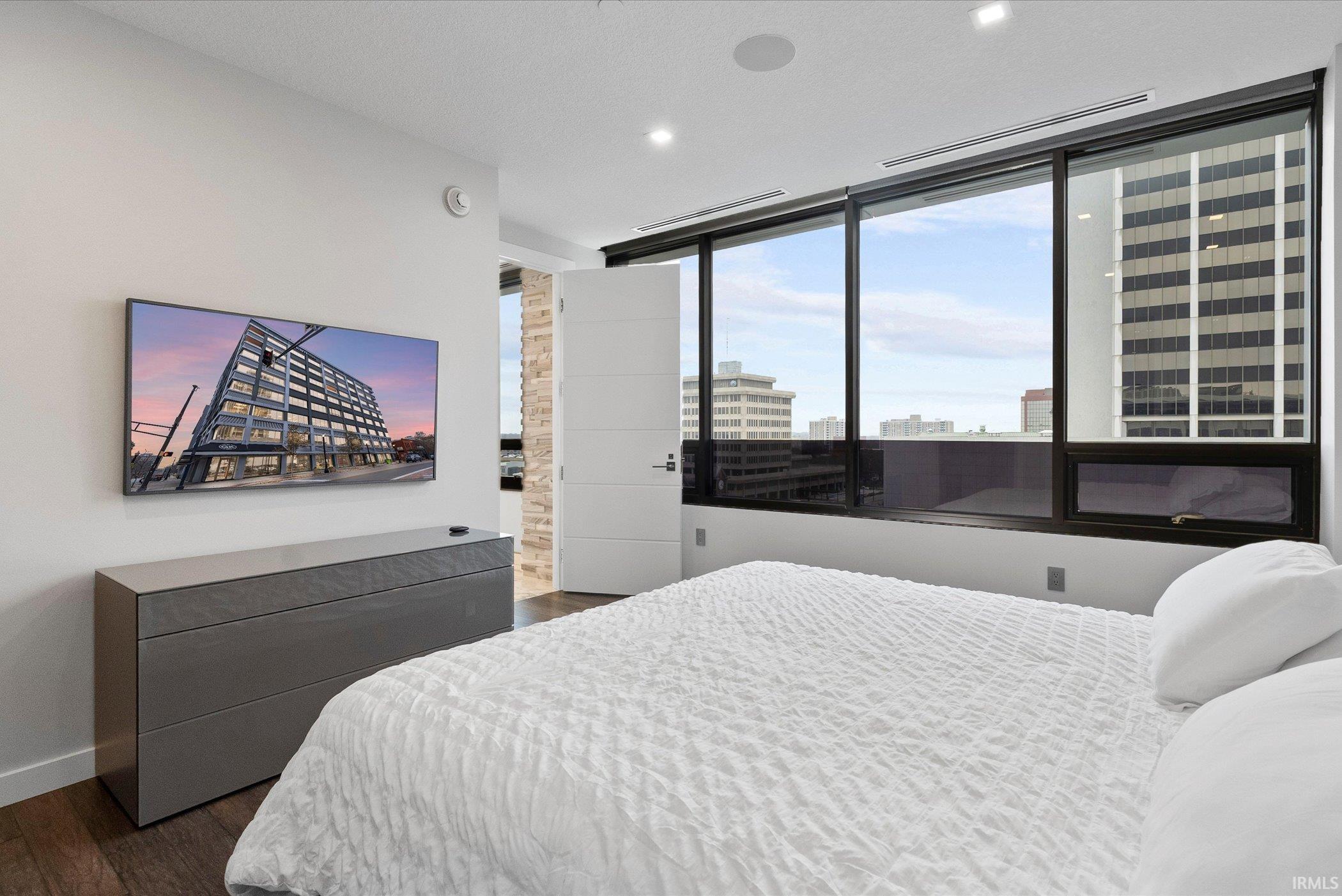 Bedroom featuring dark wood finished floors and recessed lighting