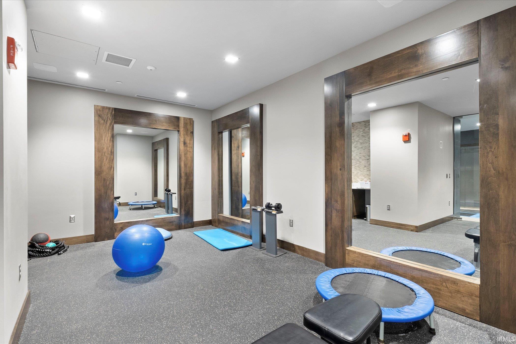 Exercise area featuring recessed lighting