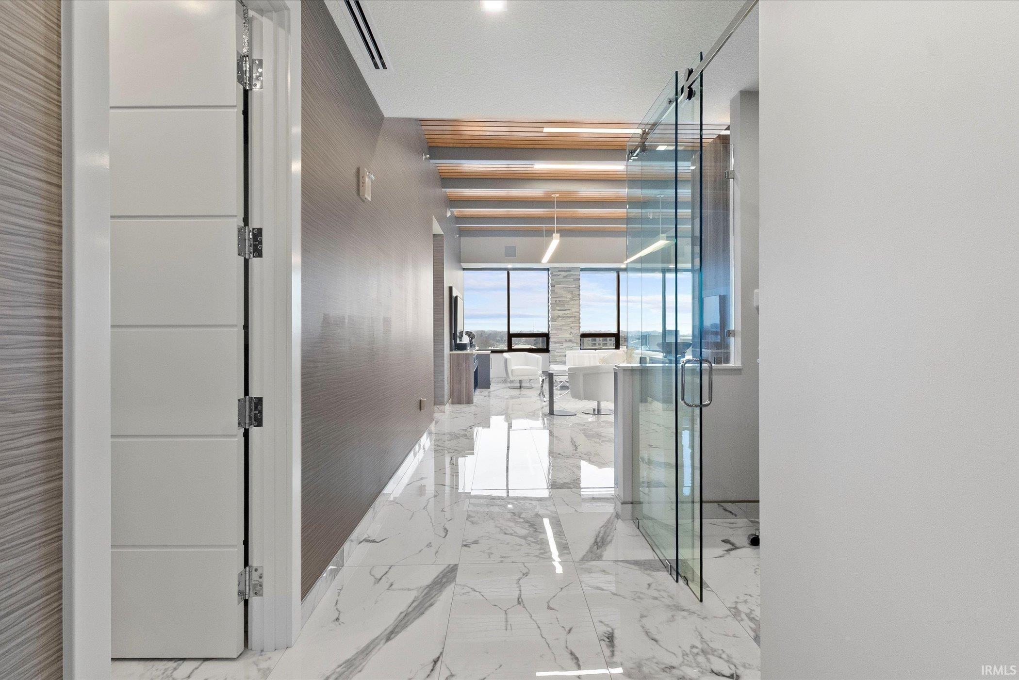 Hall featuring marble tiled floors