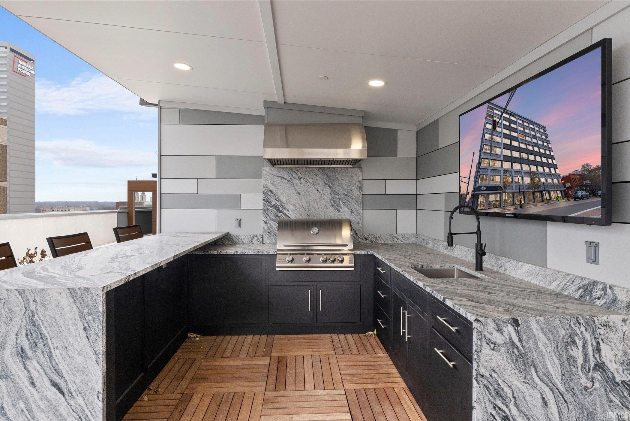 View of patio / terrace featuring an outdoor kitchen and a sink