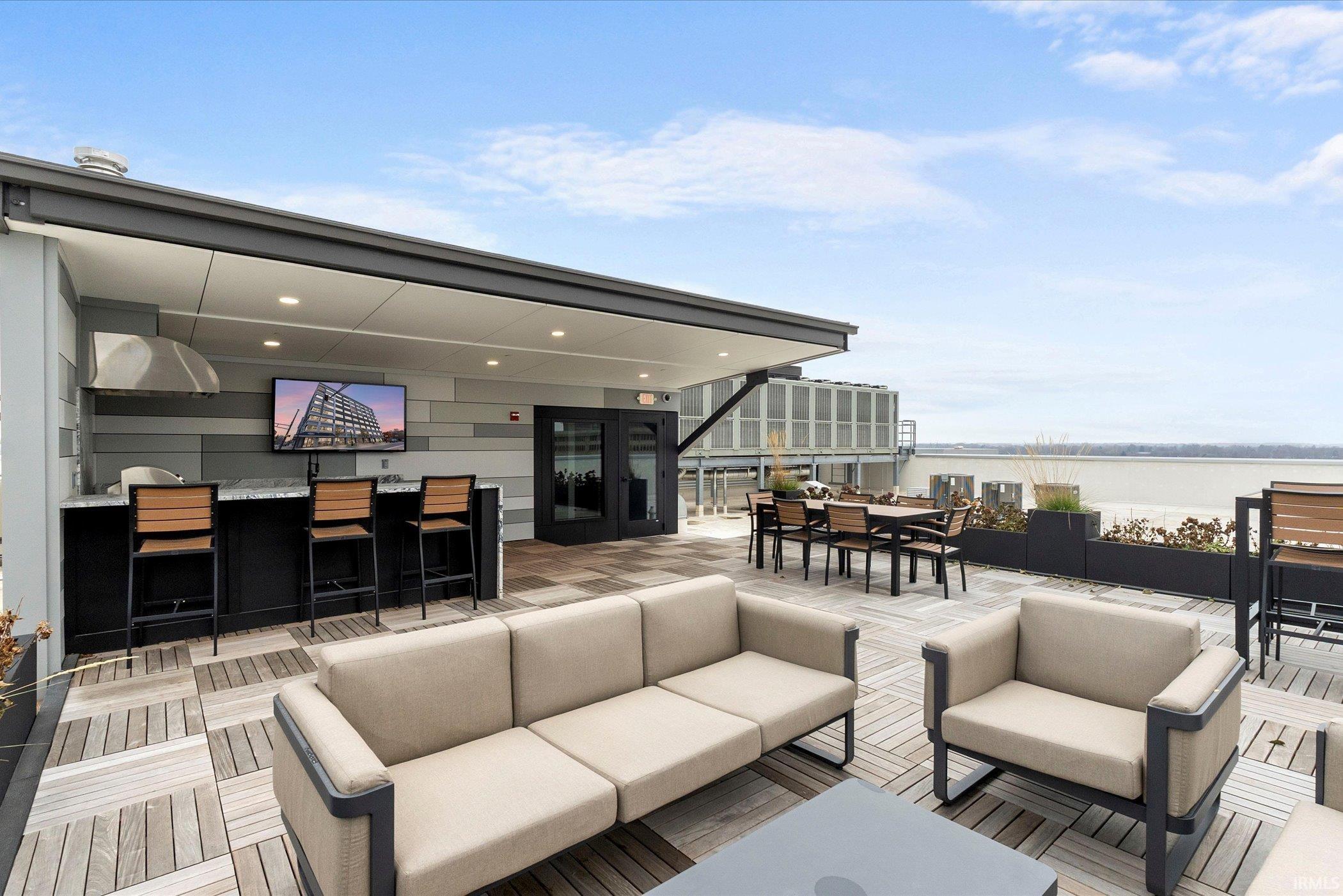 Wooden deck featuring outdoor dining area and an outdoor hangout area