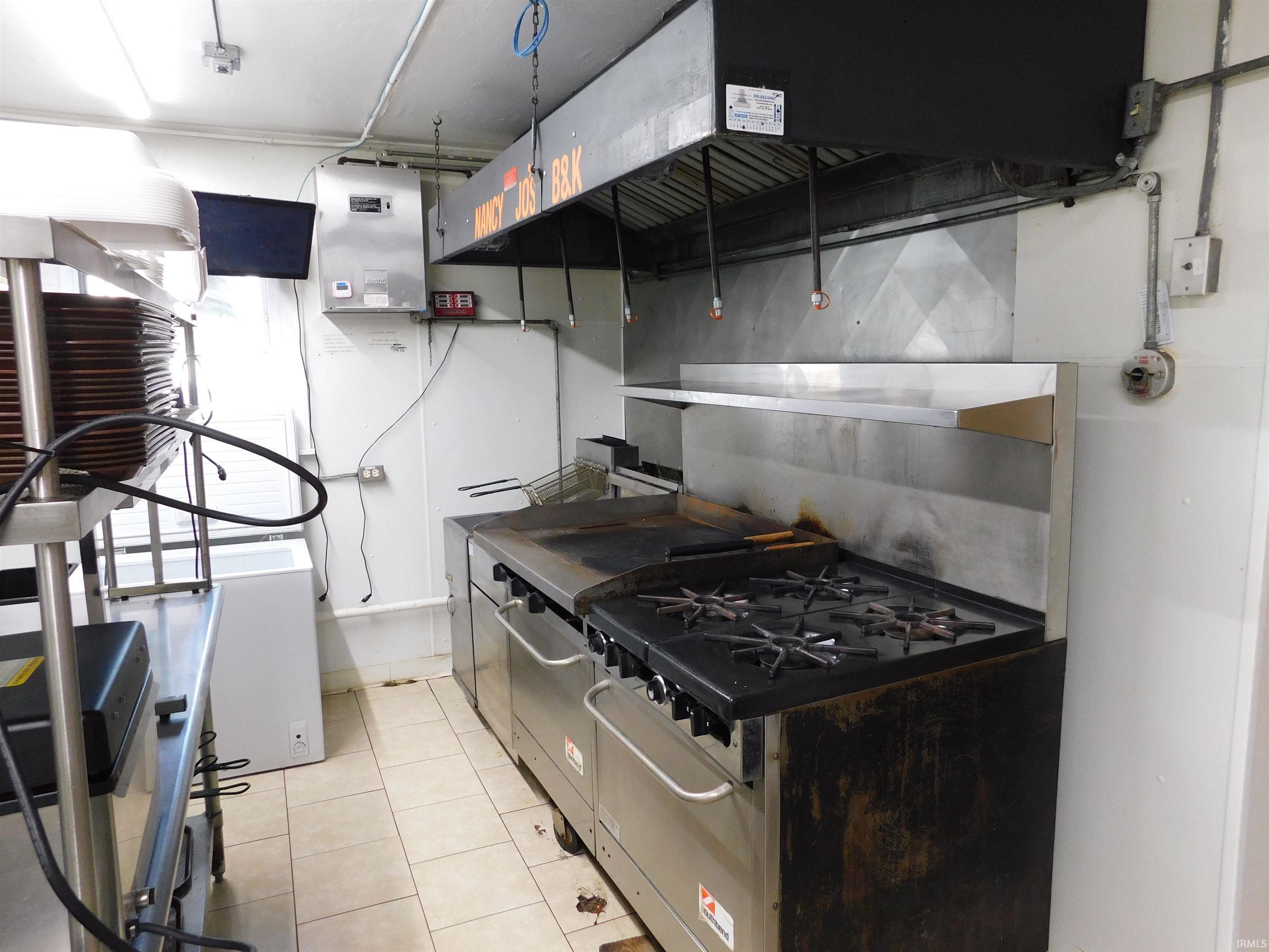 Kitchen featuring range hood and fridge