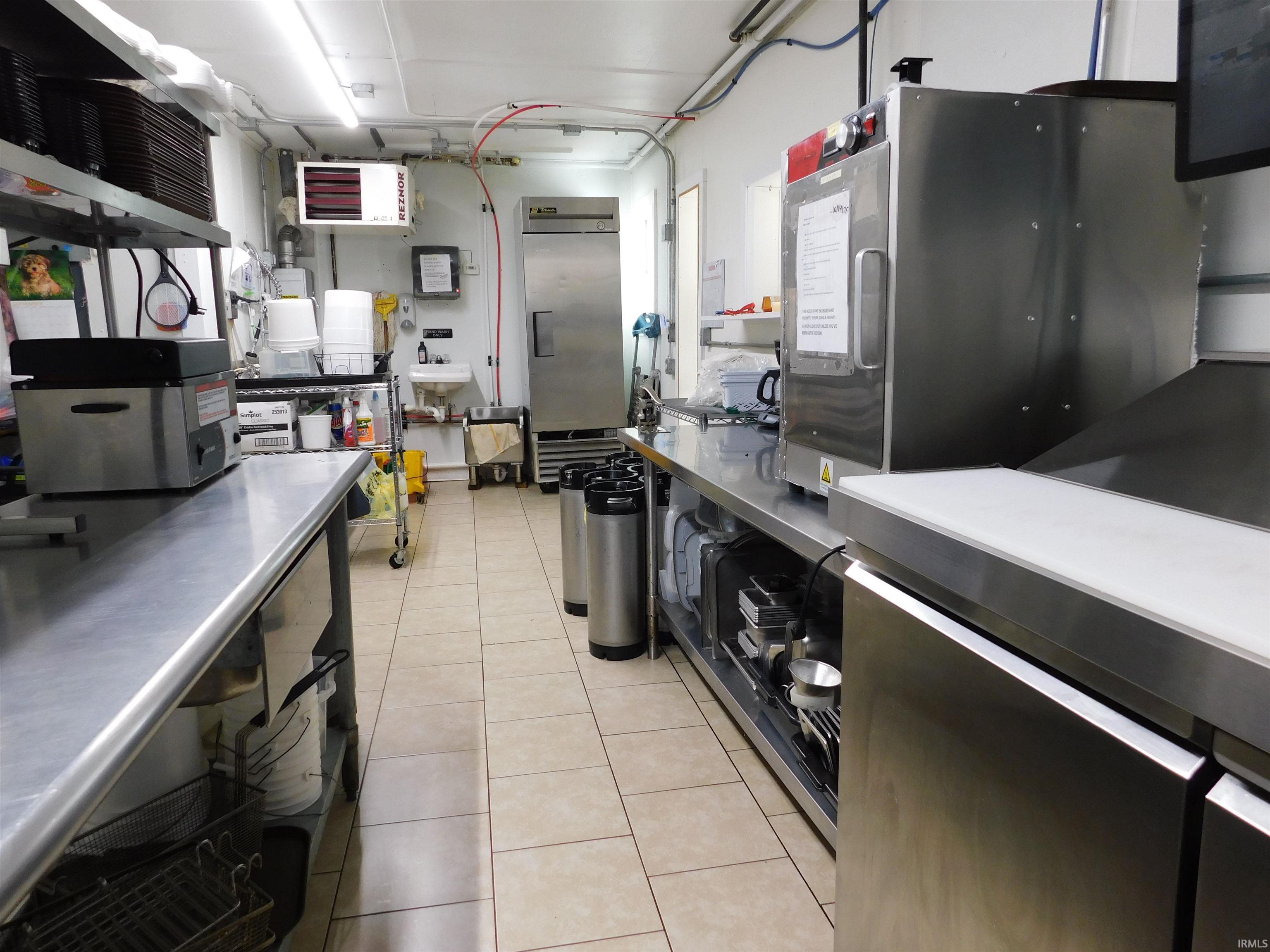 Kitchen featuring stainless steel counters and a heating unit