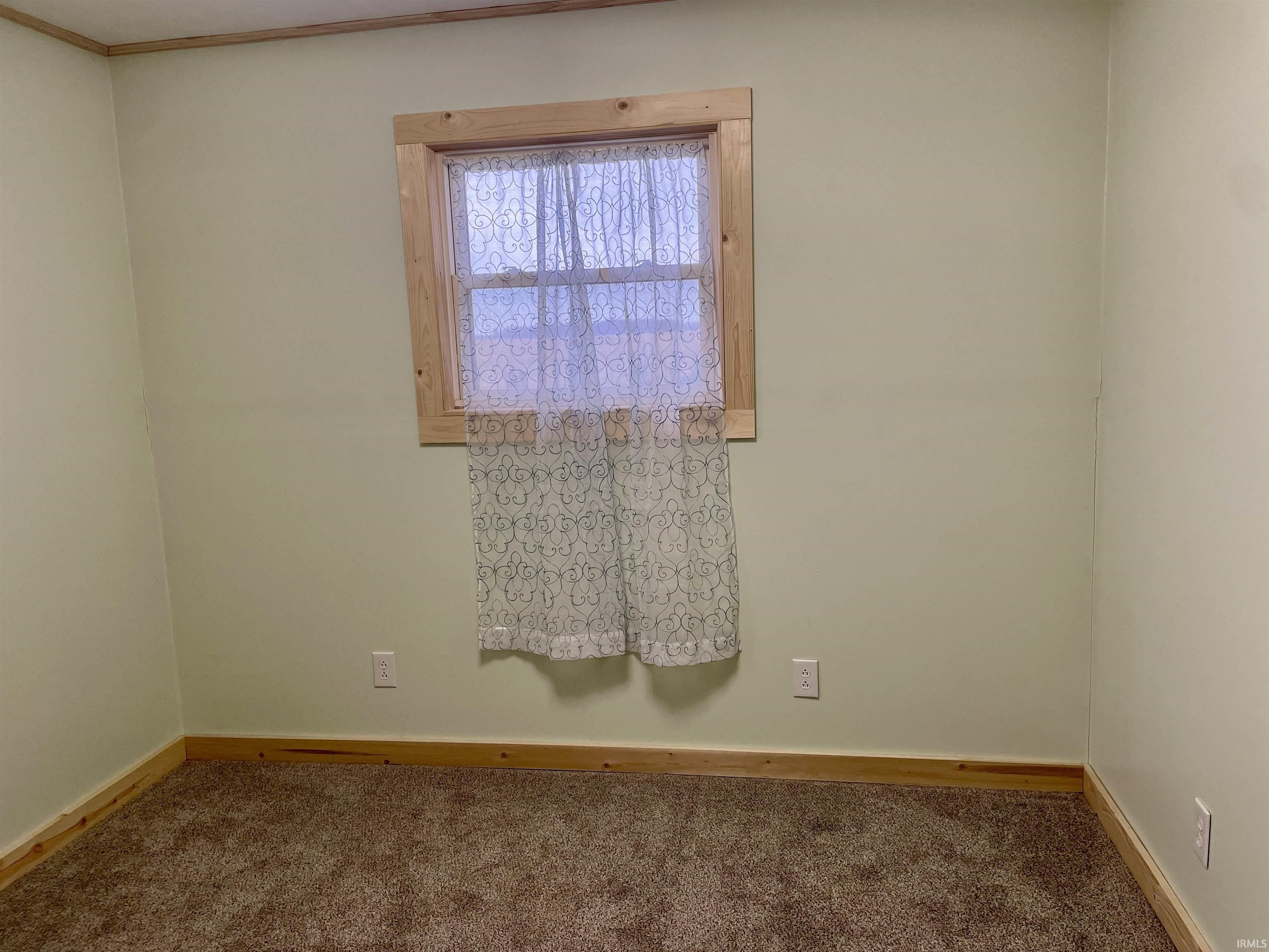 Unfurnished room featuring carpet flooring and baseboards