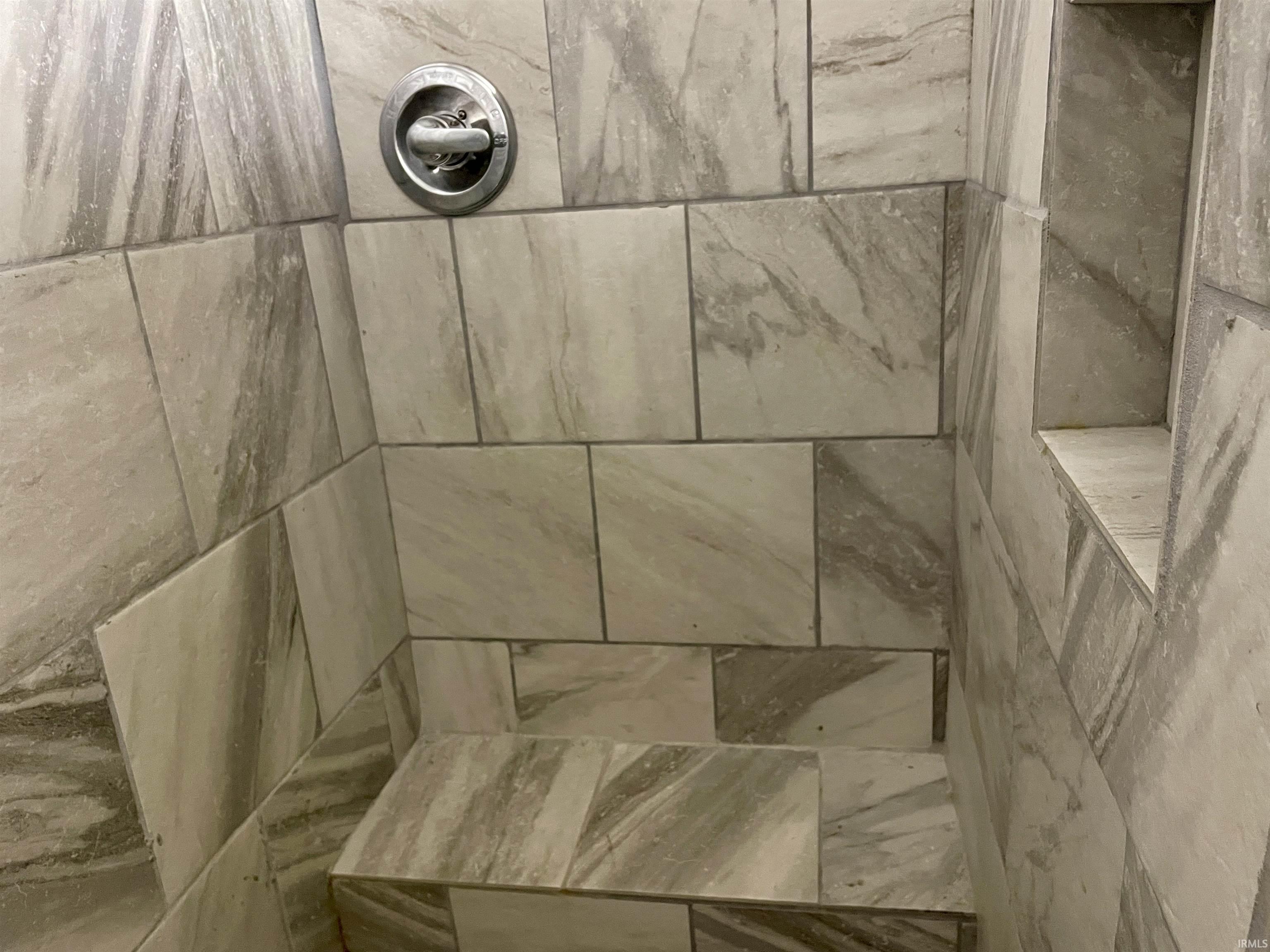 Bathroom view of a tile shower