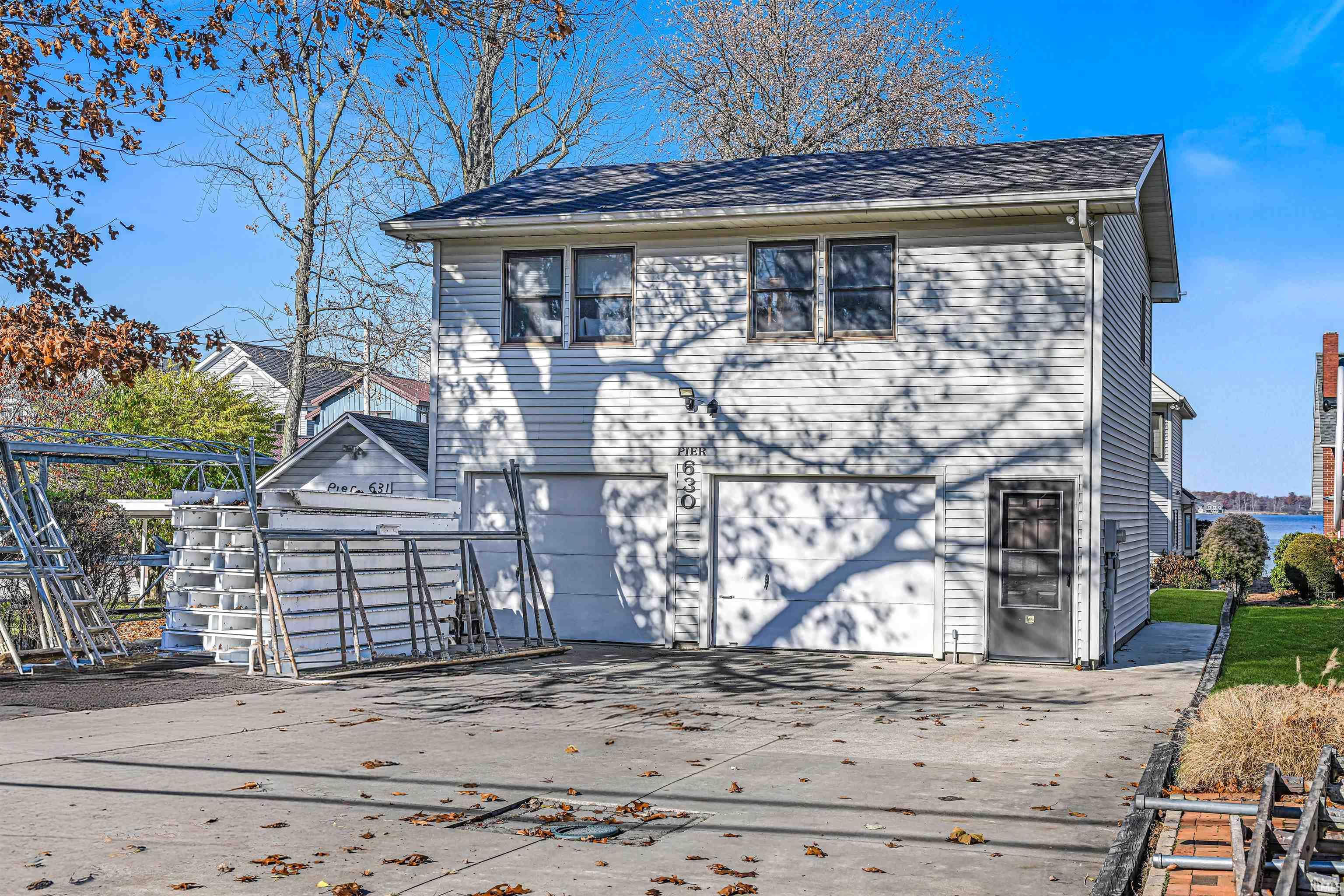 View of front facade featuring driveway and an attached garage