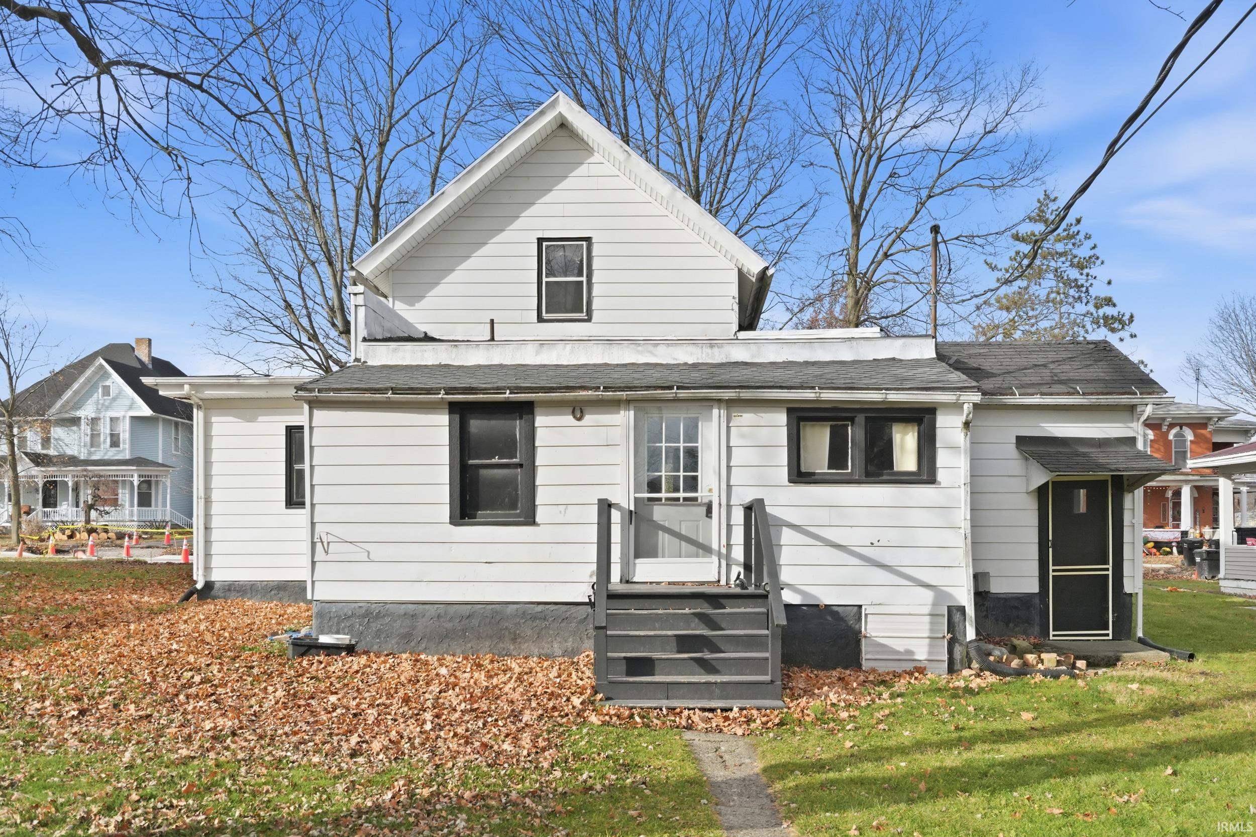 Rear view of property featuring a lawn