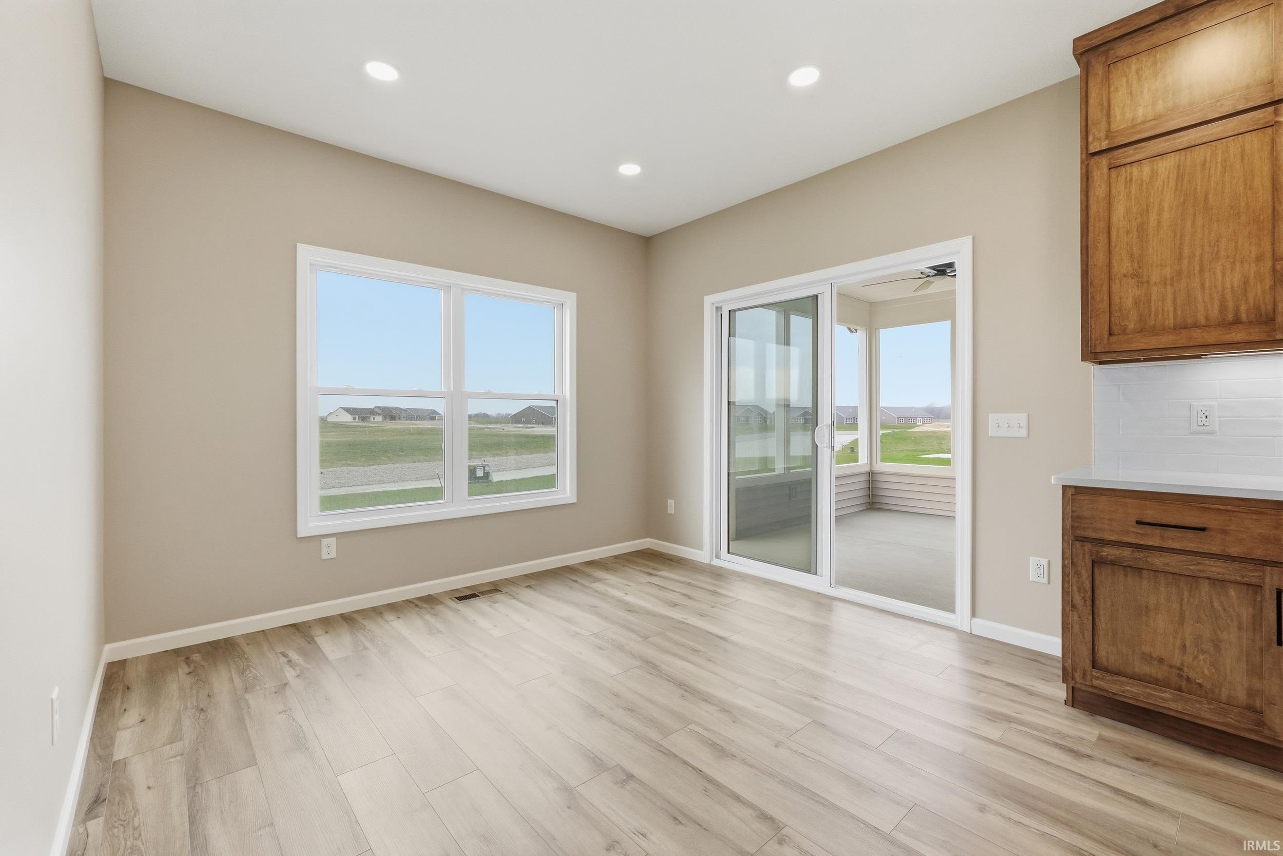 Unfurnished dining area featuring light wood-style floors and recessed lighting