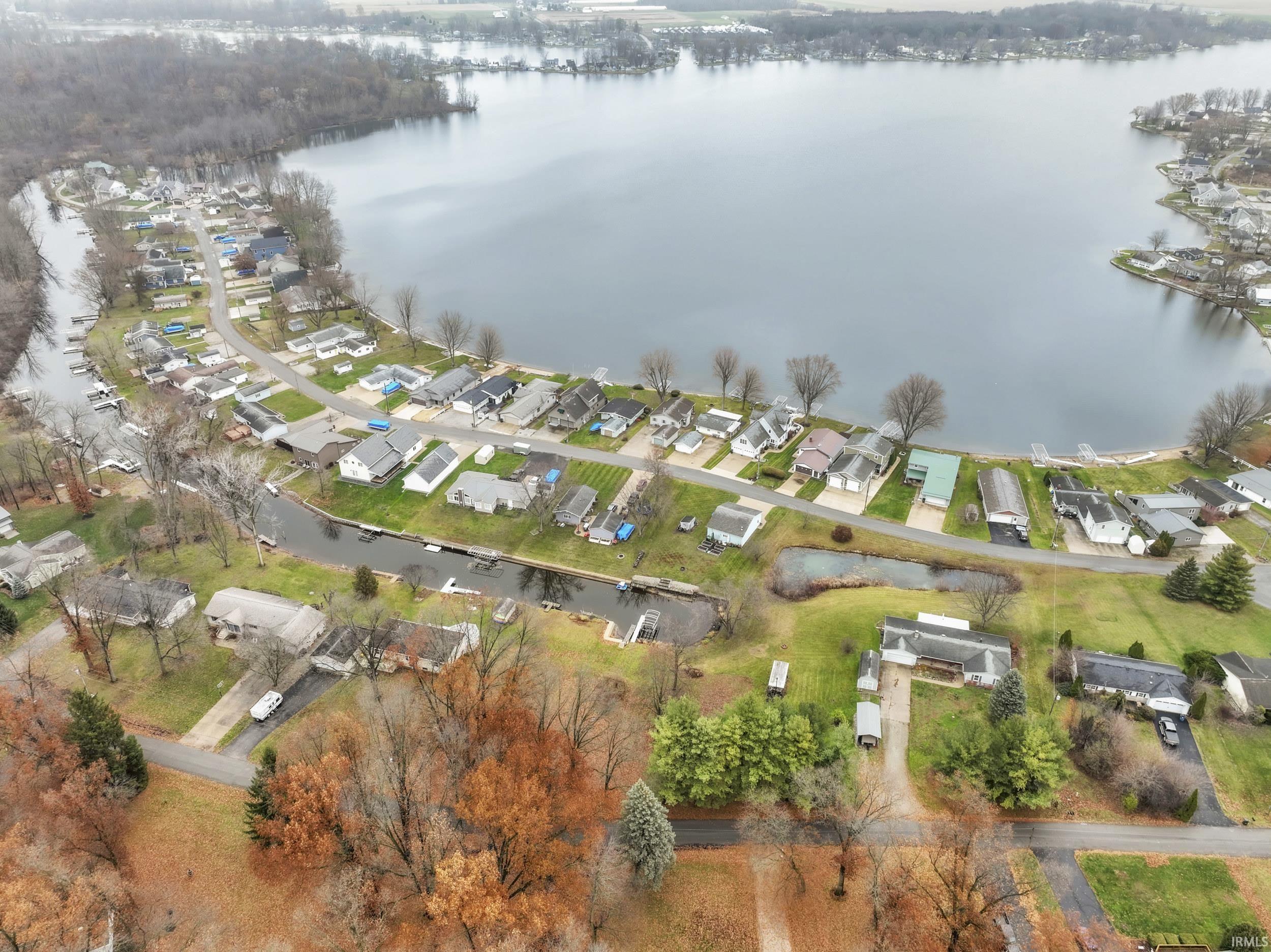 Aerial view of property and surrounding area featuring a nearby body of water