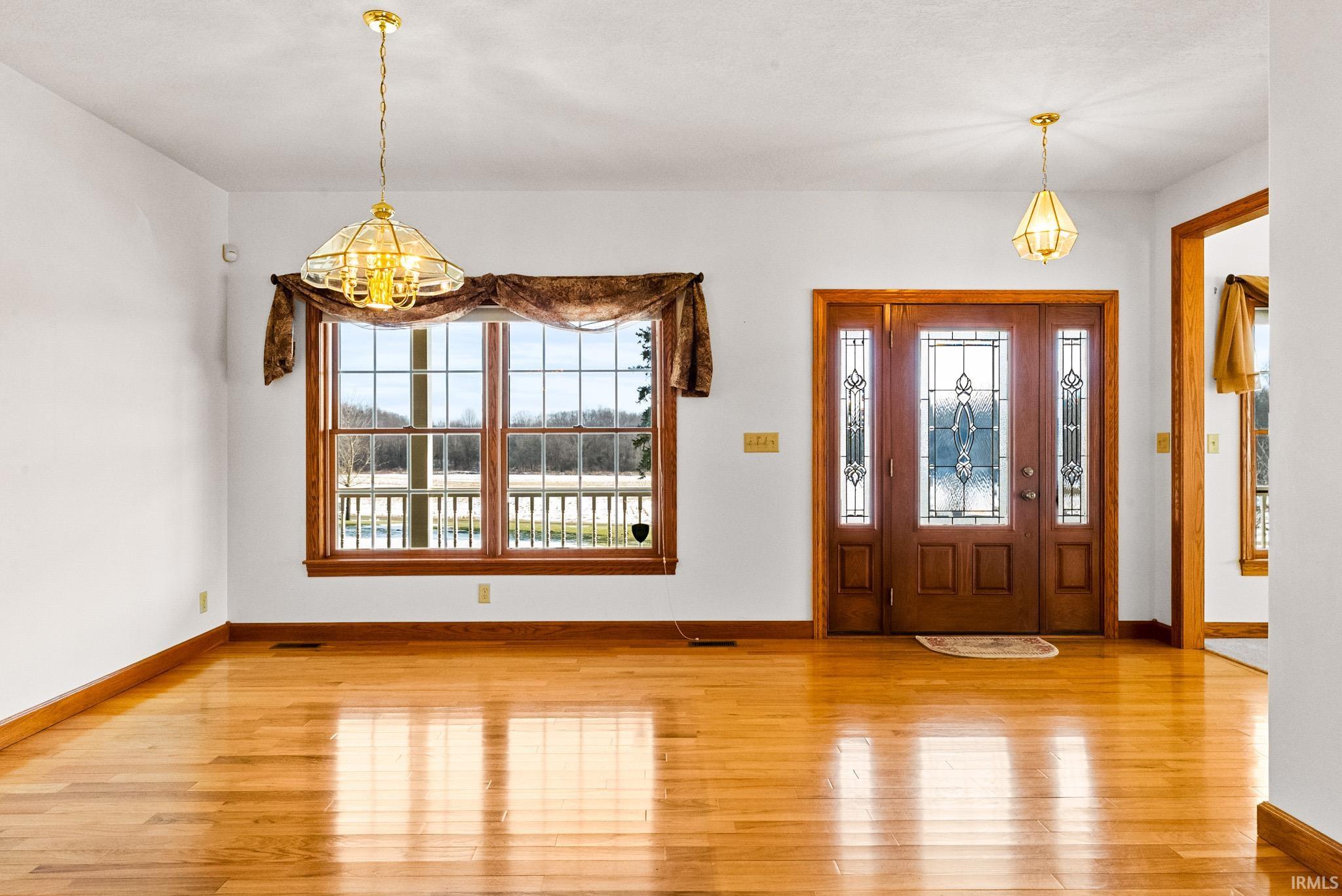 Entryway featuring a chandelier and light wood-style floors