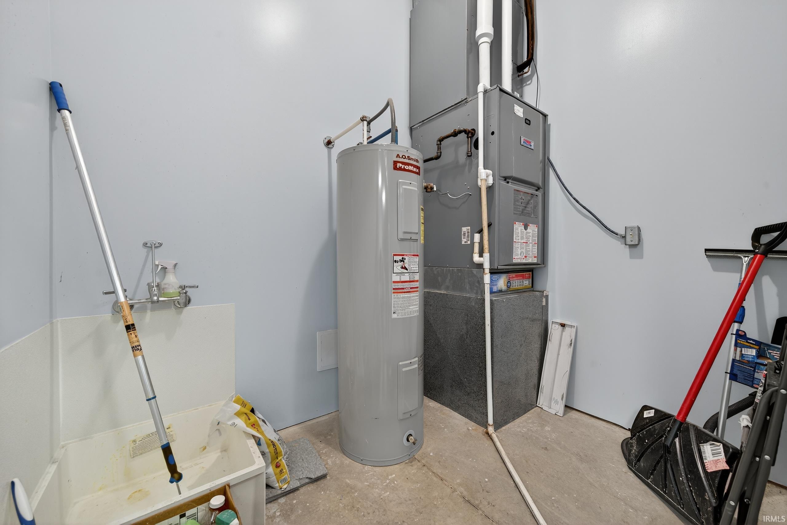 Utility room with electric water heater and heating unit