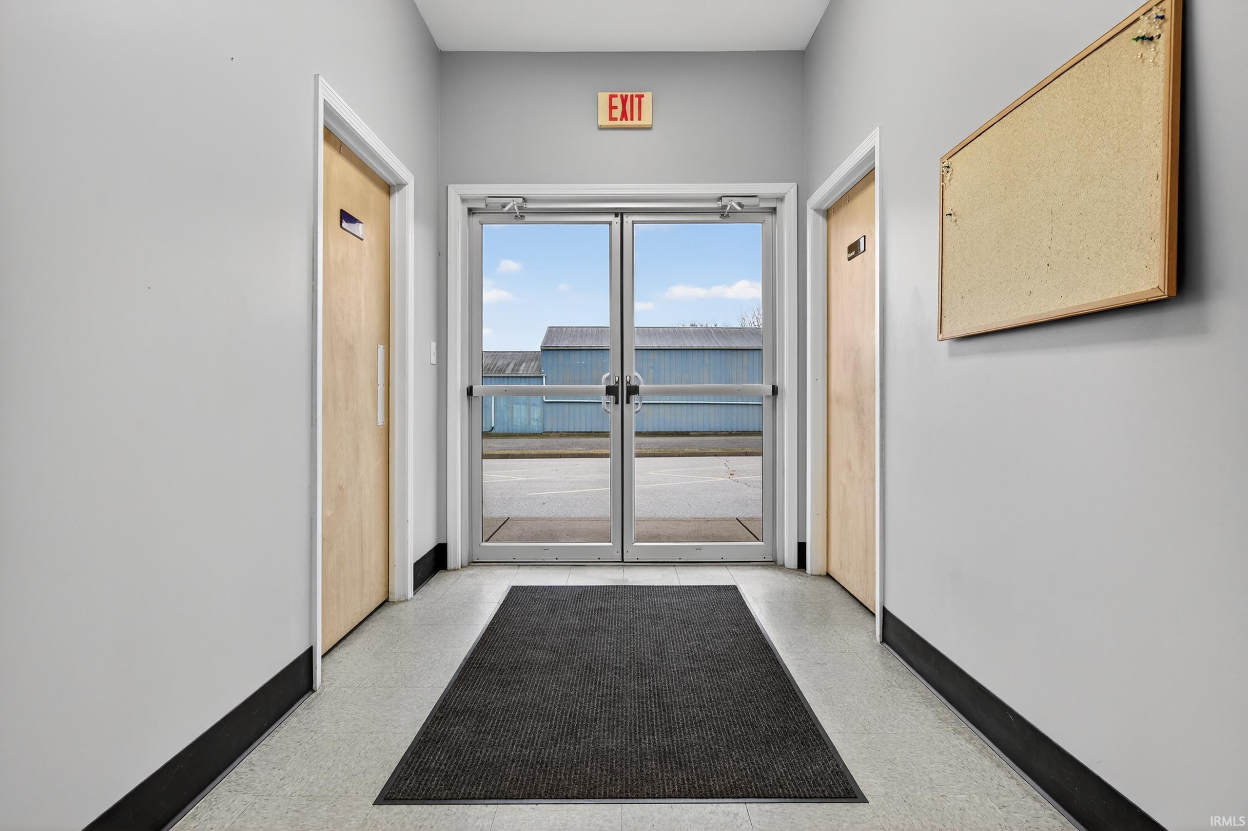 Corridor with baseboards and french doors